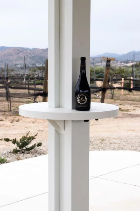 Wine bottle resting on a white AlumaTable