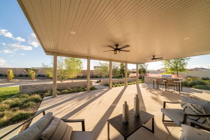 Large patio cover with AlumaBase post base covers installed shown in photo during sunset