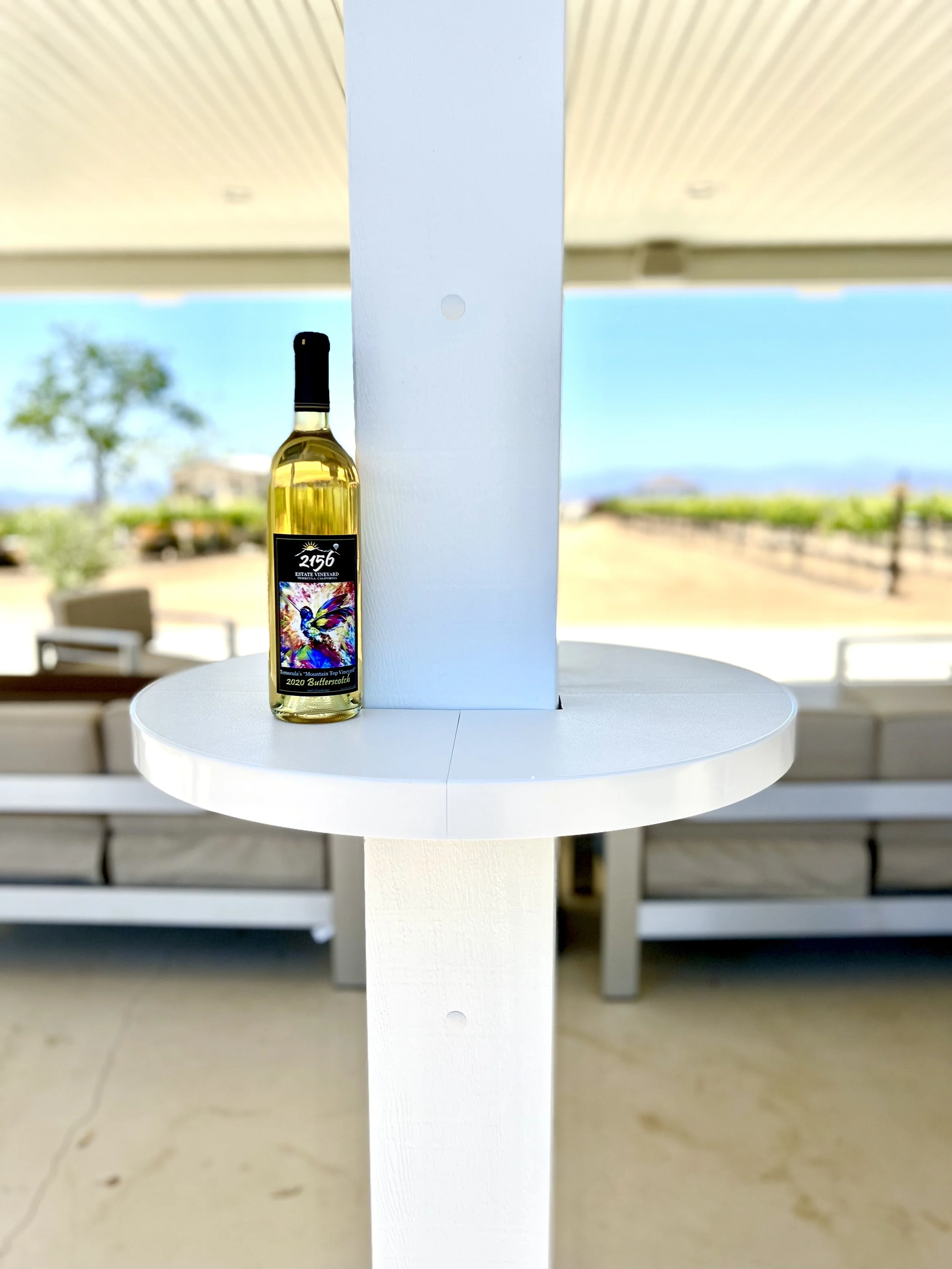 White bottle resting on a white AlumaTable