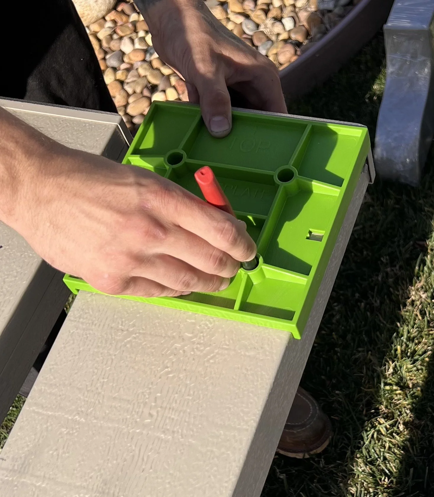 Person using the sideplate jig to mark up a patio cover sideplate