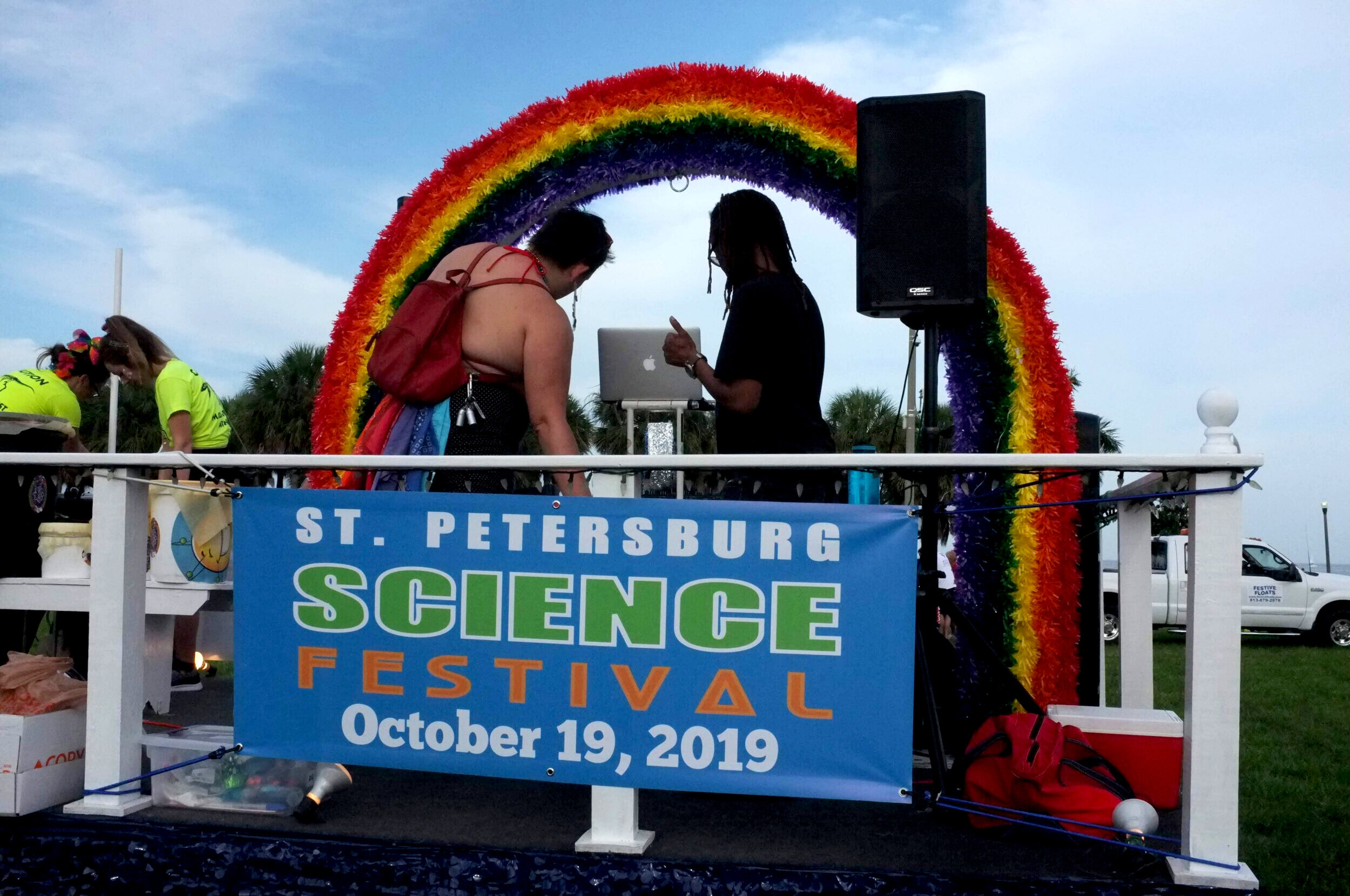  DJ setting up music for the St Pete science festival float at St Pete pride 