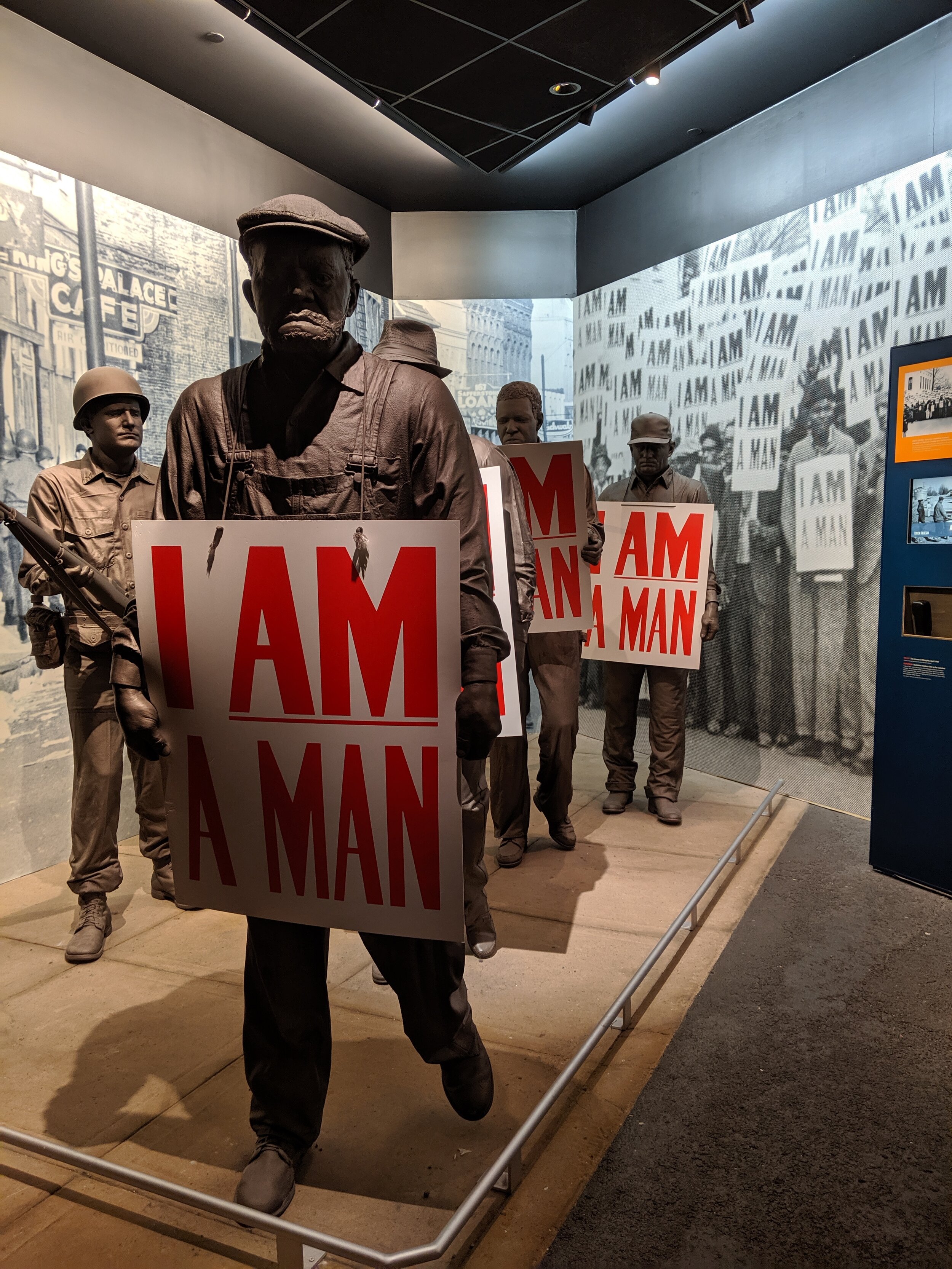  Sculpture at the Civil rights museum in Memphis of men holding signs saying “I am a man”. 