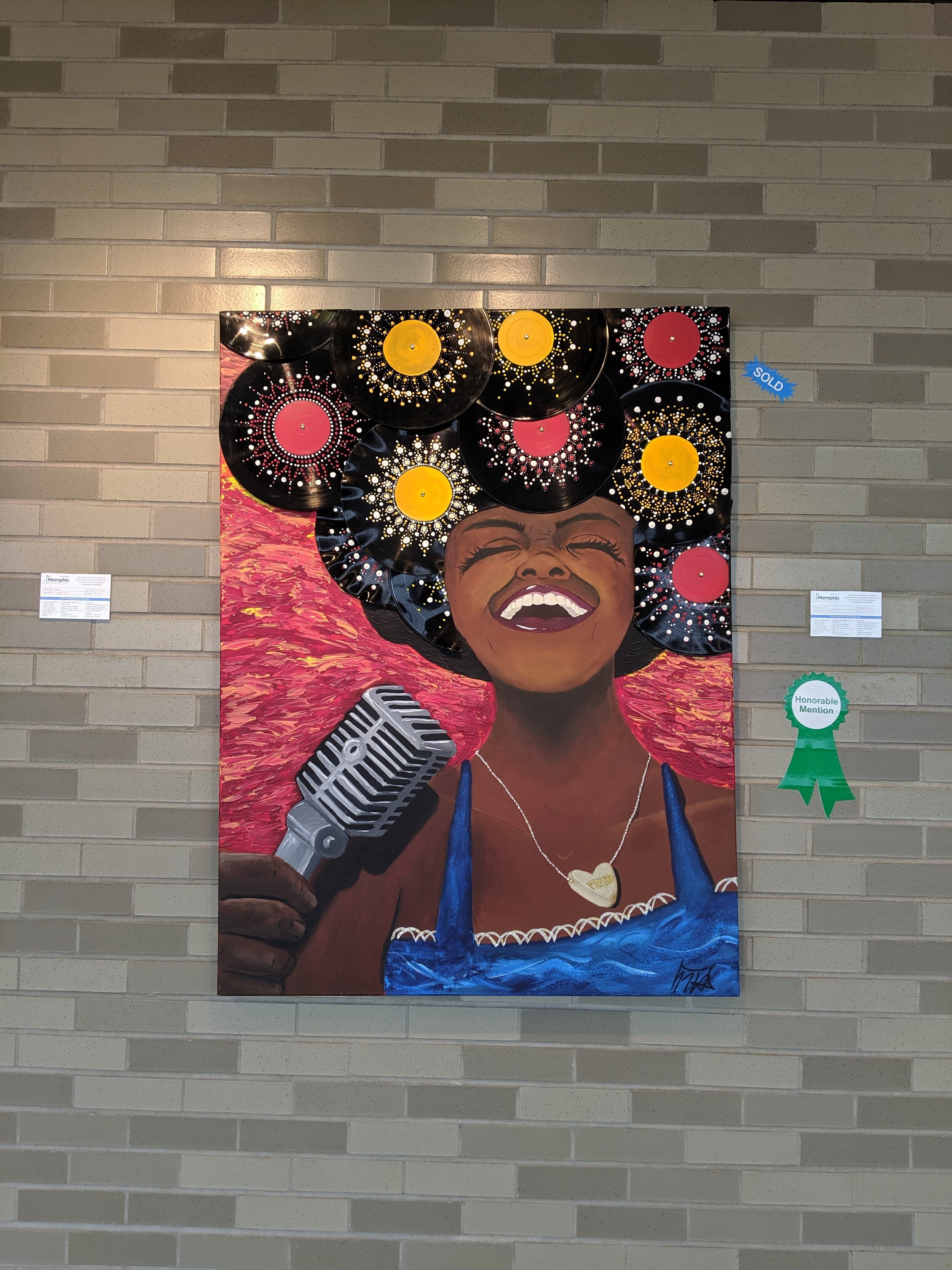  Art at the airport in Memphis. A painting of a singer whose hair is made from records. 