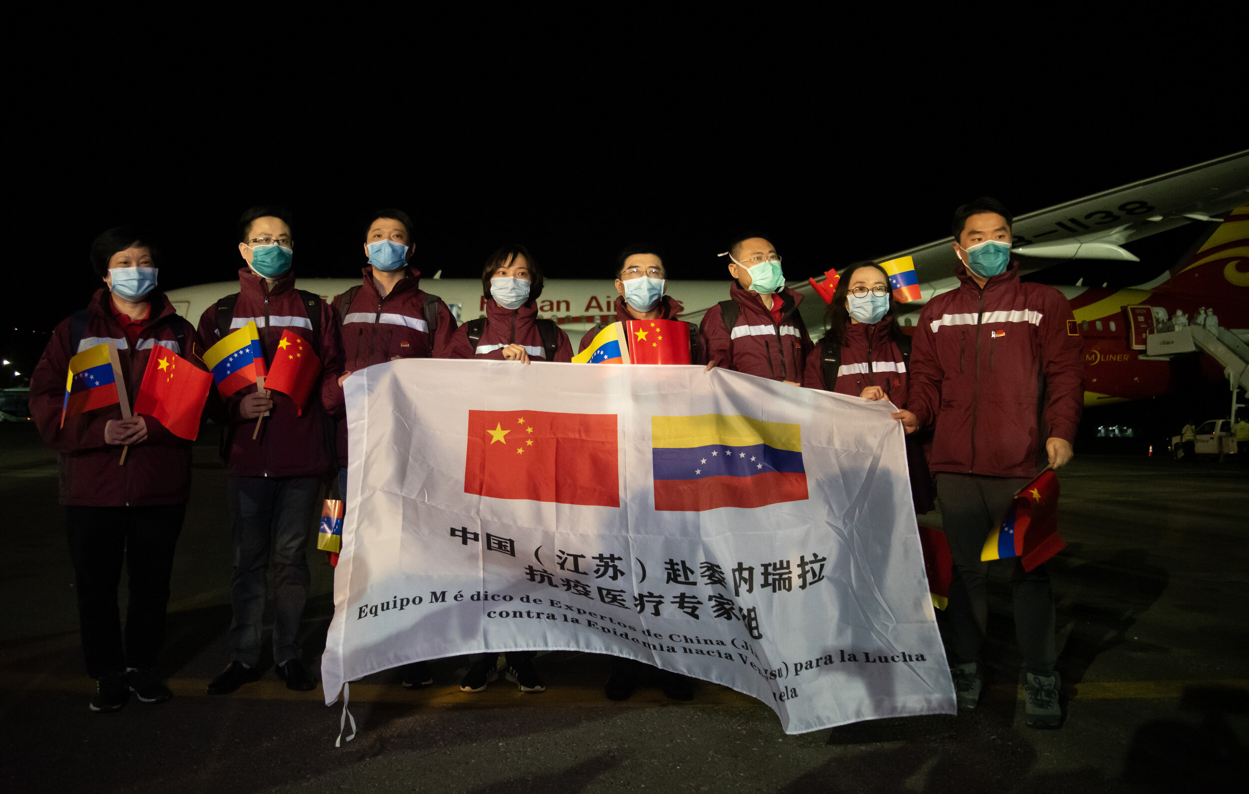 Chinese medical experts pose at the Simon Bolivar International Airport, in La Guaira, Venezuela, on March 30, 2020. (Source: Xinhua/Marcos Salgado)