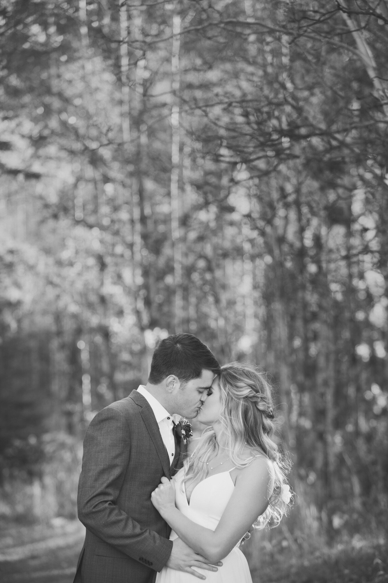 wedding couple kissing fall hiking trail canmore black white.jpg