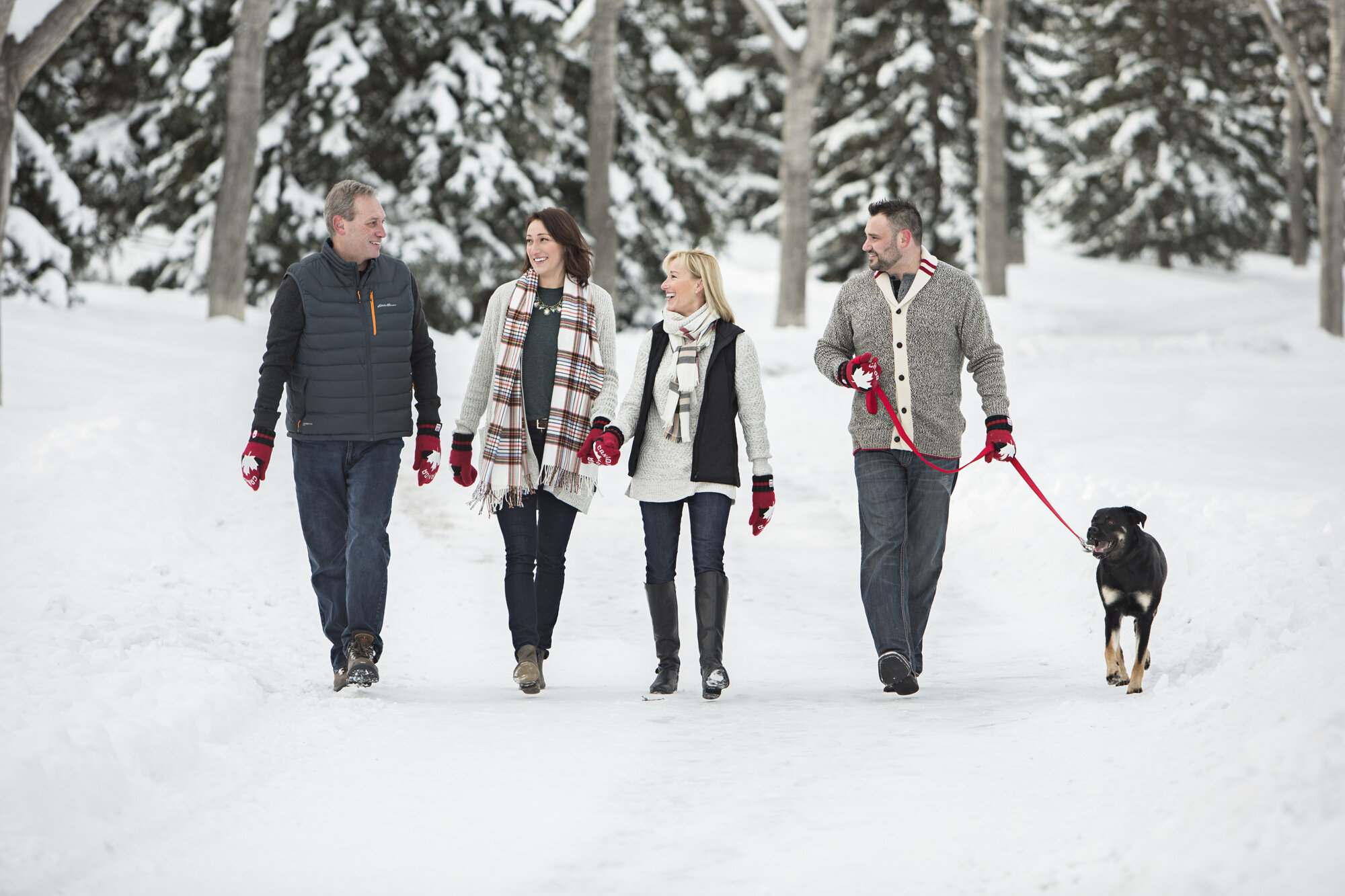 calgary family photography bliss photographic family walking outside winter with dog.jpg