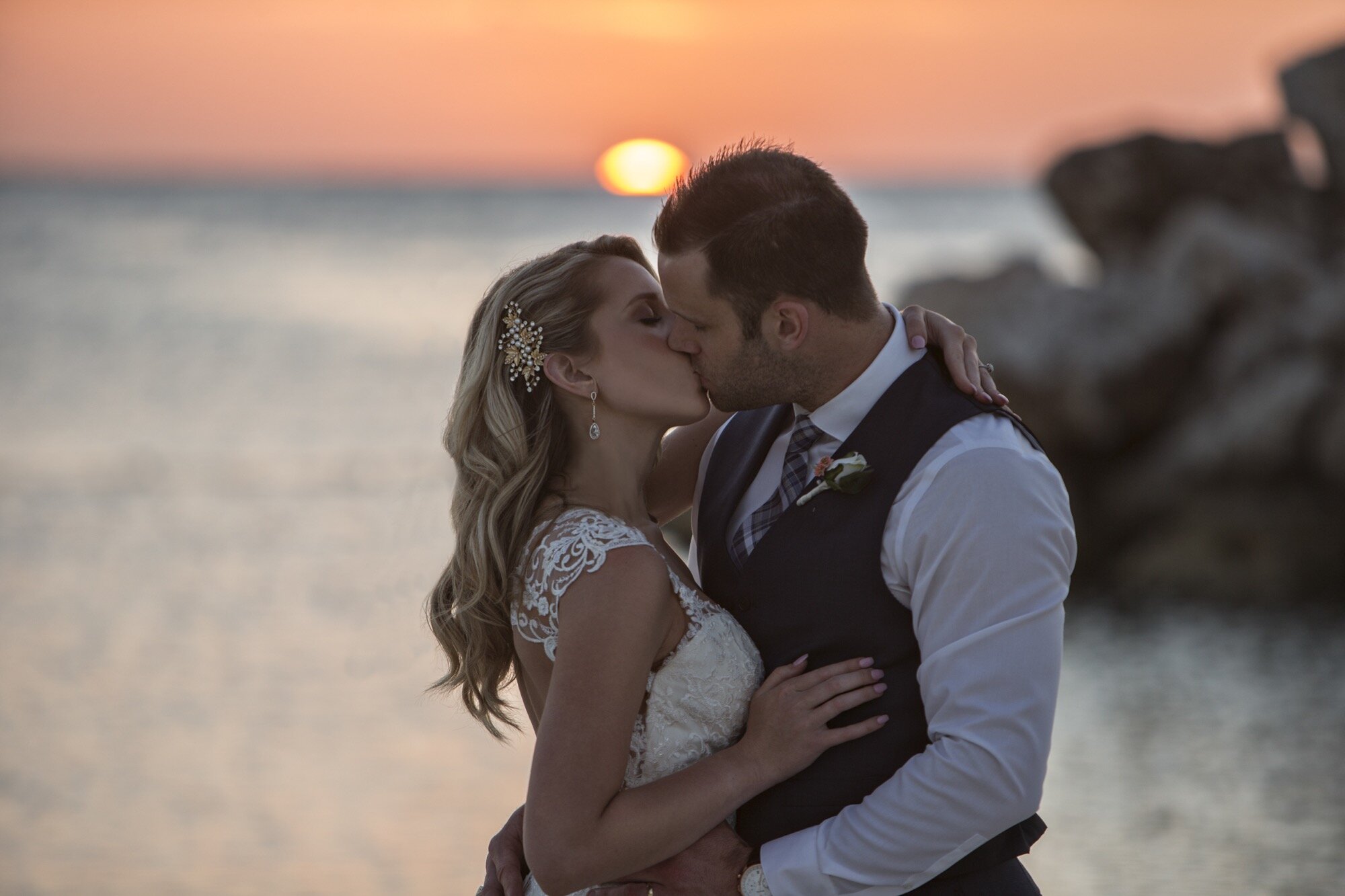 bride groom kissing beach sunset jamaica.jpg