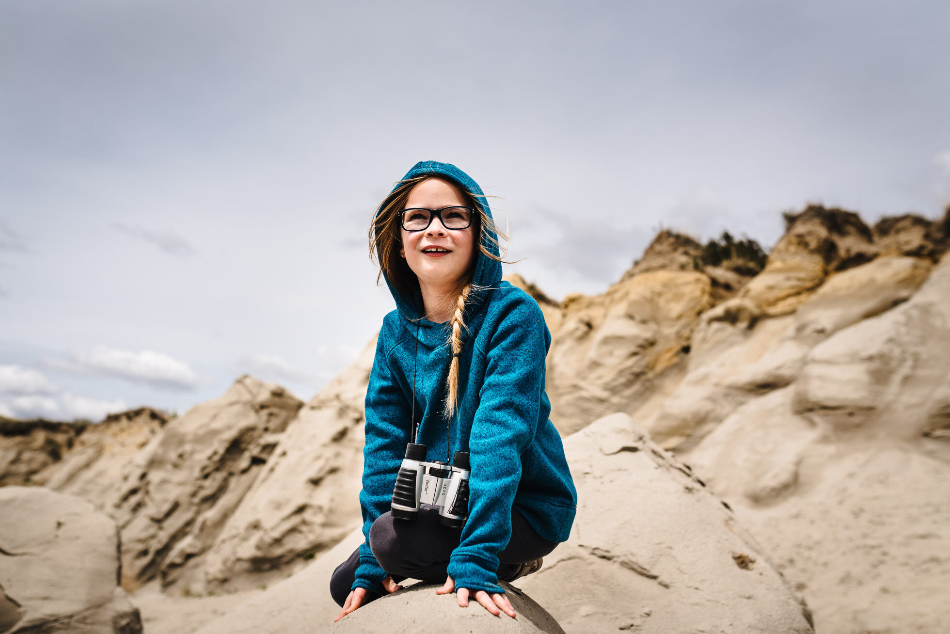girl-explore-badlands-binoculars-wind-rocks-documentary-north-dakota-lyra-lee-dp.jpg