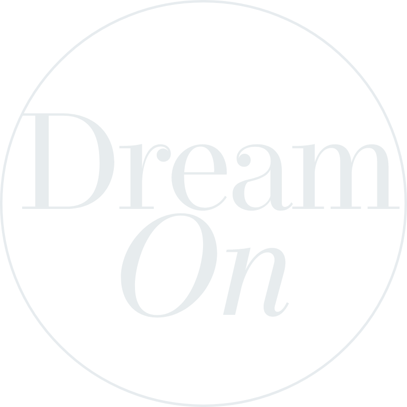 A circular logo with a black background and white text that reads 'Dream On'.