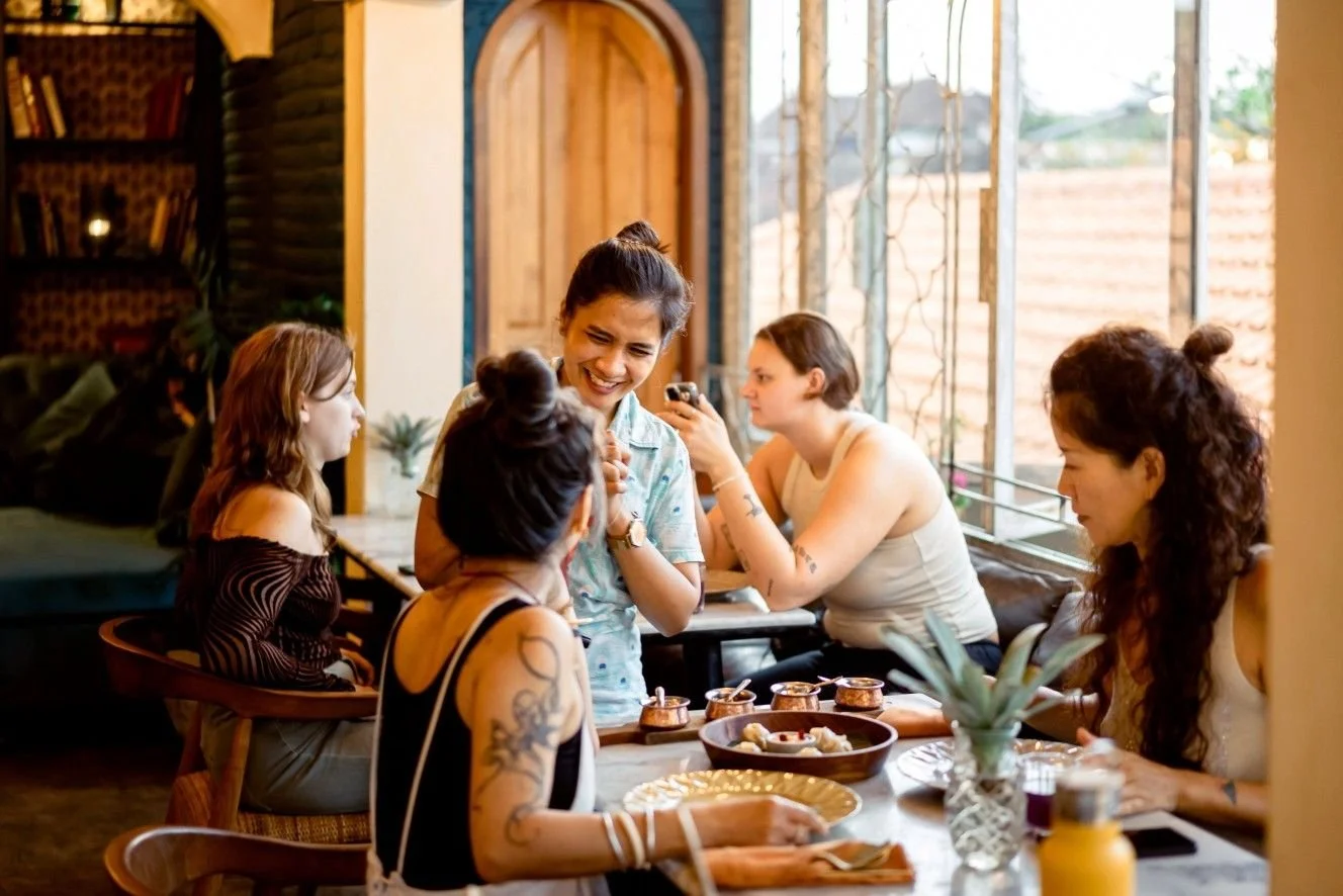 Friends sharing a meal together at Pesona Lounge Ubud in Bali.
