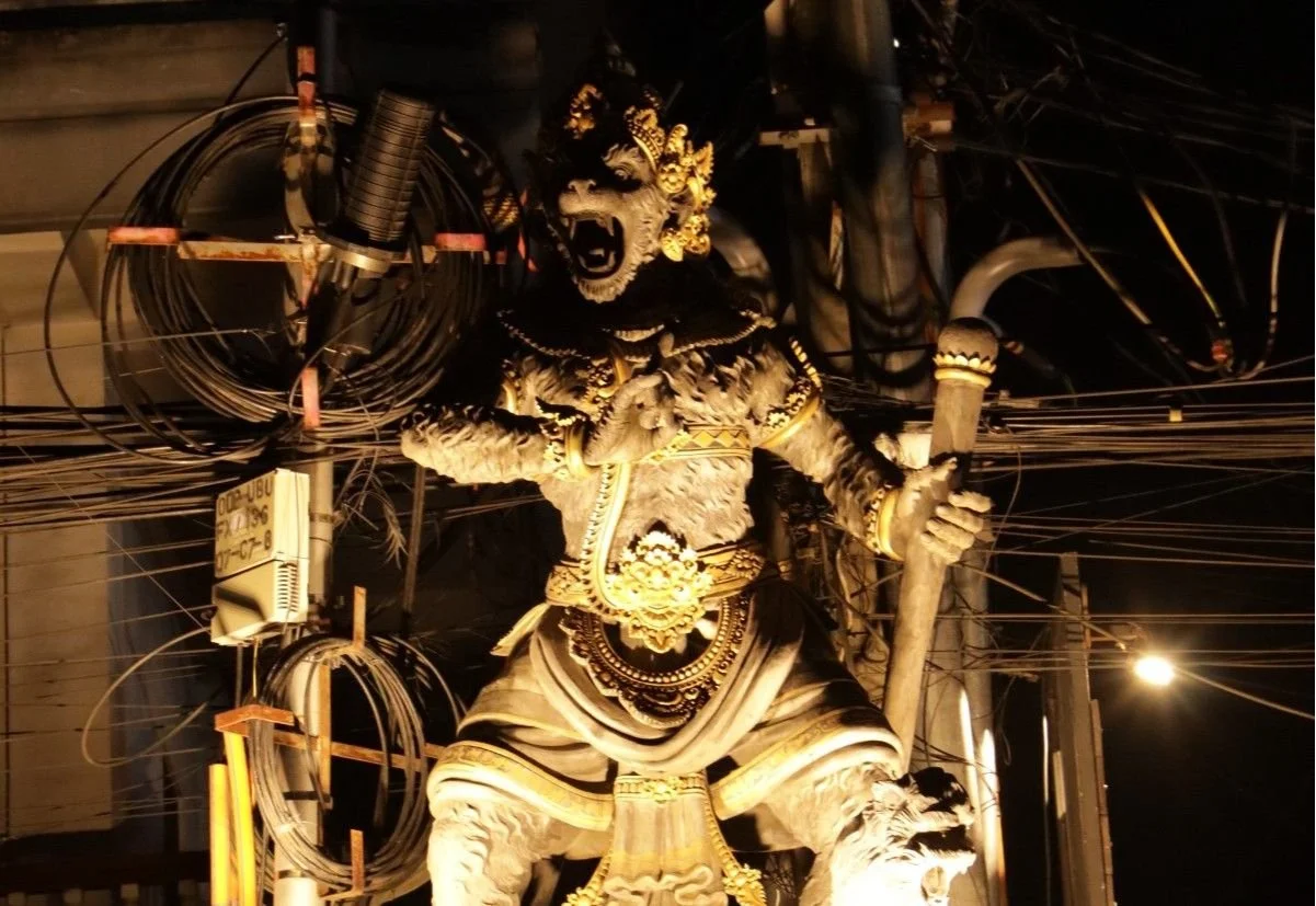 Traditional Balinese statue illuminated at night in central Ubud, Bali.
