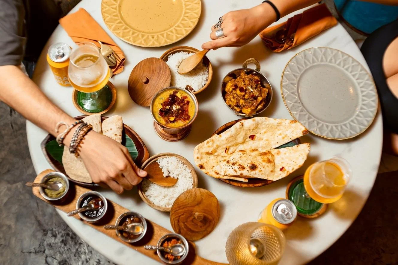 Indian dining table featuring naan, rice, and signature curries at an Indian restaurant in Ubud.