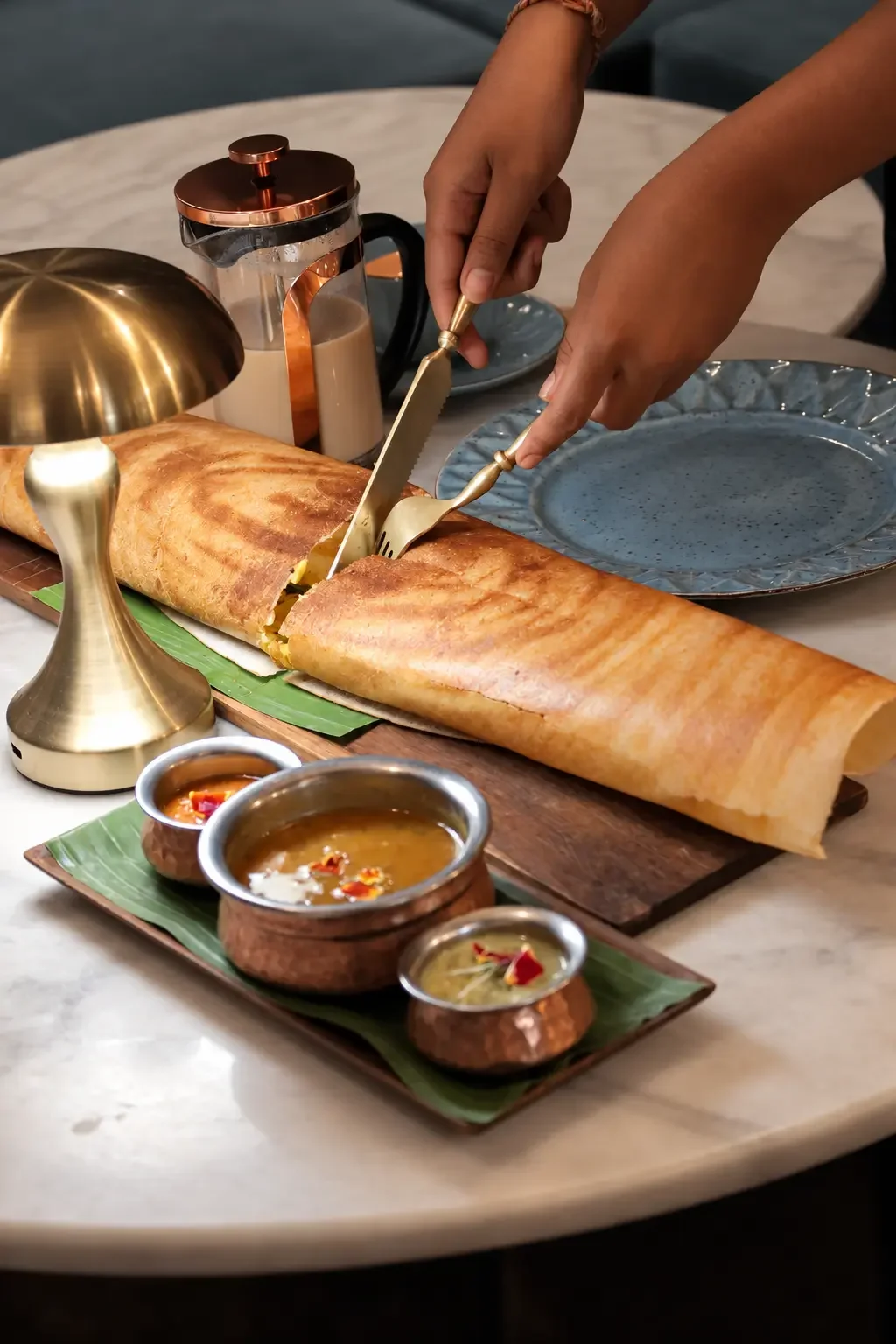 Slow-crafted oversized dosa stuffed with masala potatoes, served with sambar, coconut & tomato chutneys.