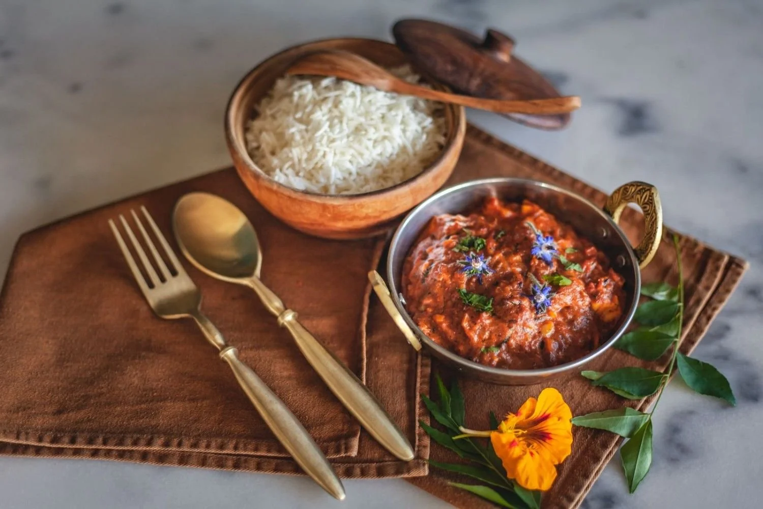 Paneer Masala served with steamed basmati rice in a traditional Indian serving bowl.