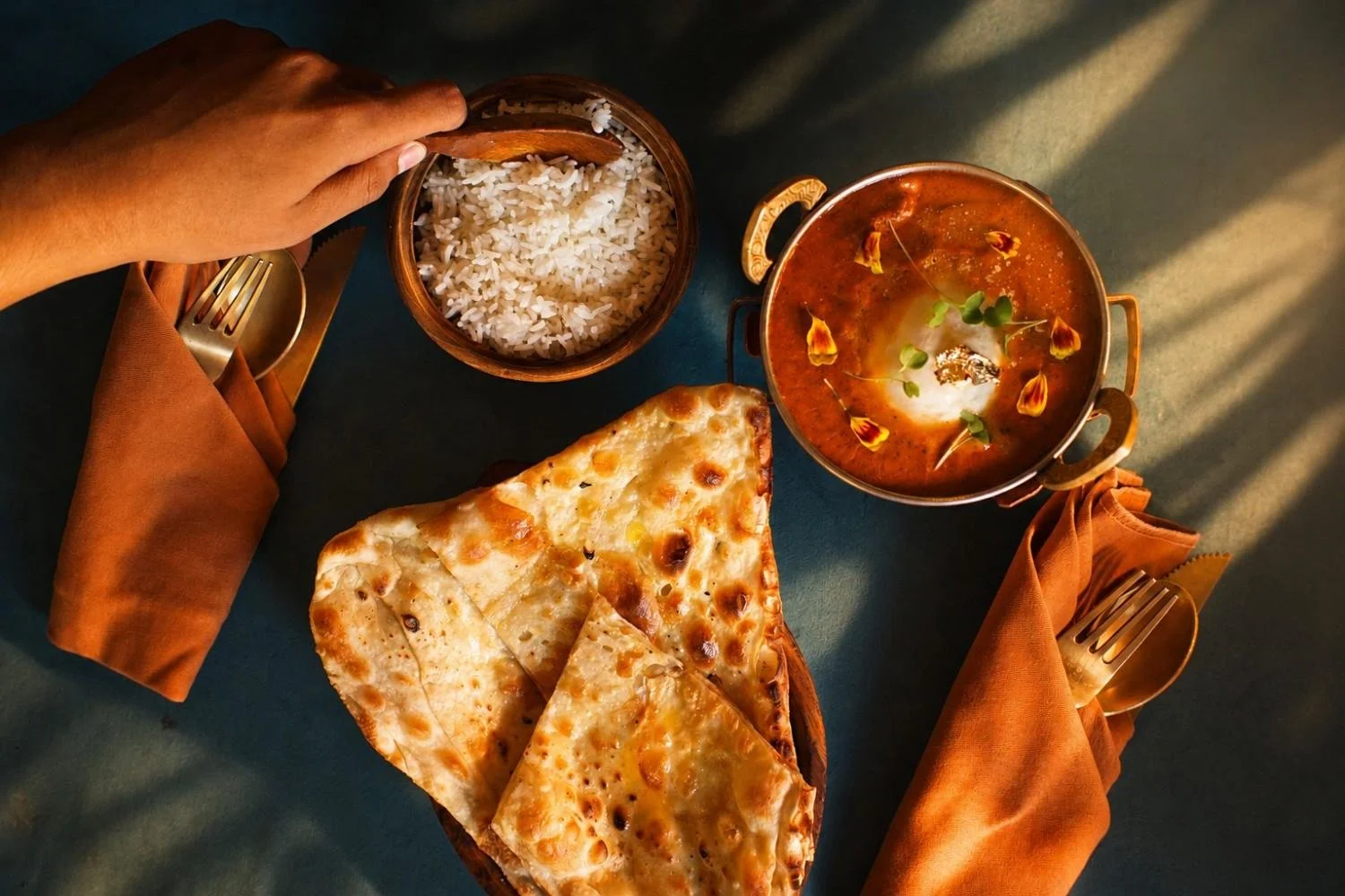 Butter chicken served with burrata, naan bread, and steamed rice at an Indian restaurant in Ubud