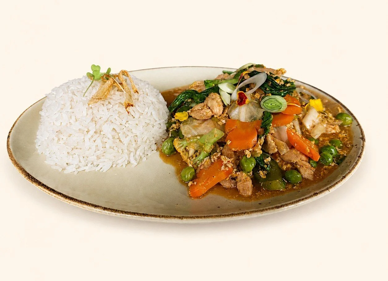 Chicken and vegetable stir-fry served with steamed rice, a wholesome Indonesian comfort food at Pesona Lounge Ubud.