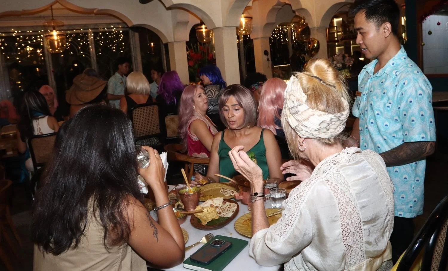 Guests enjoying Indian food together in a lively restaurant in Ubud