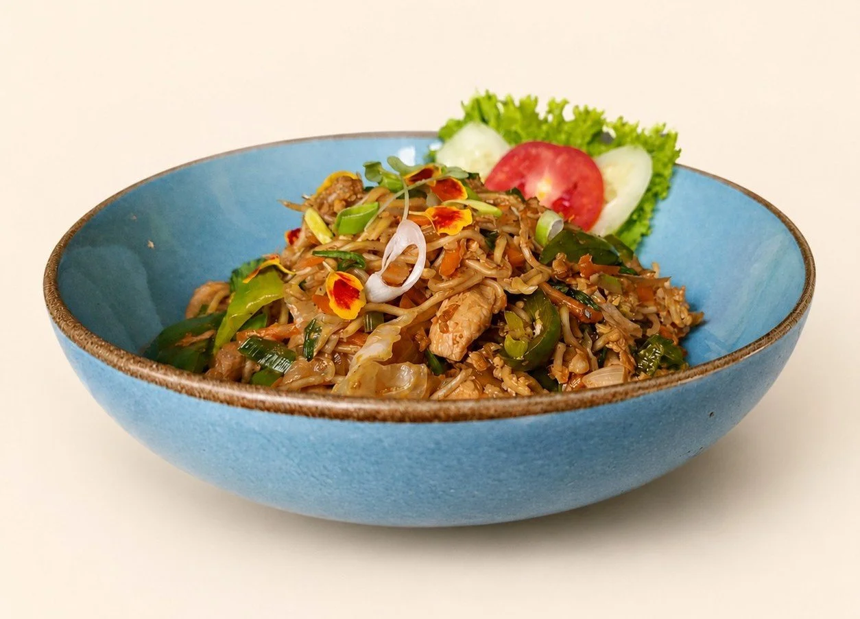 Indonesian stir-fried egg noodles with chicken, fresh vegetables and savoury seasoning at Pesona Lounge Ubud.