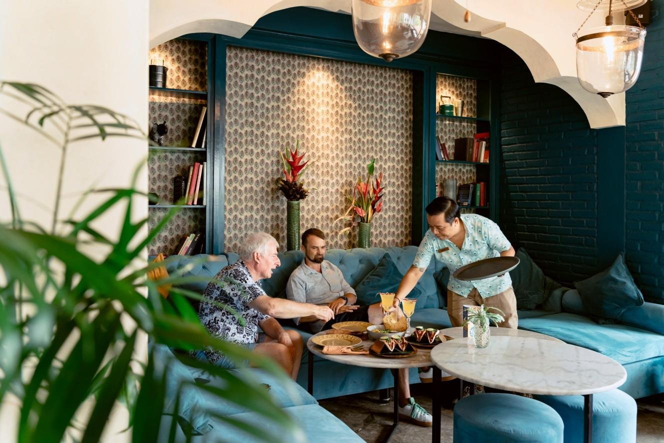 Guests relaxing at Pesona Lounge while enjoying authentic Indian cuisine and attentive service in Ubud.