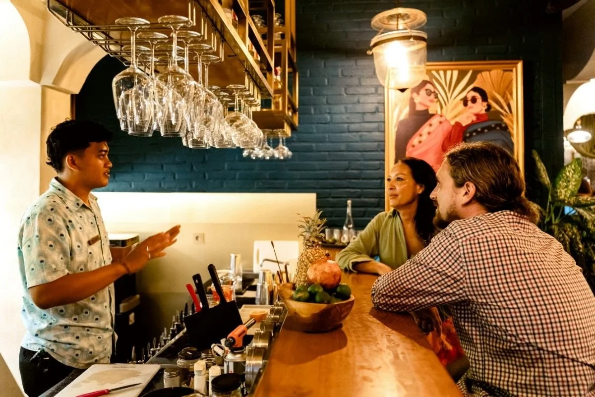 bartender talking with guests at pesona lounge ubud