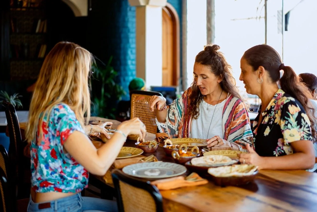 Friends enjoying a meal together at Pesona Lounge in Ubud.