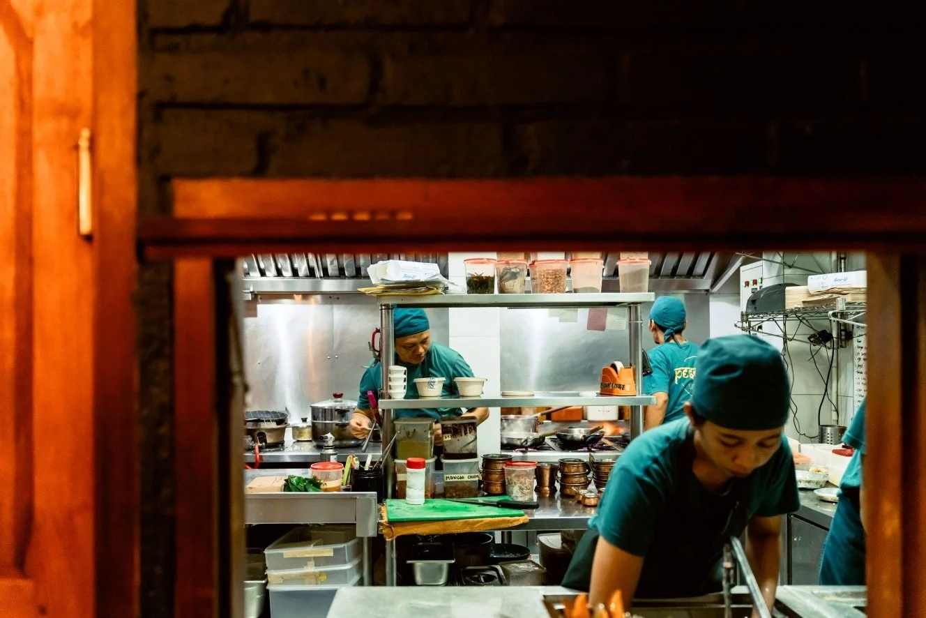 Chef preparing authentic Indian dishes in an open kitchen at Pesona Lounge Ubud.
