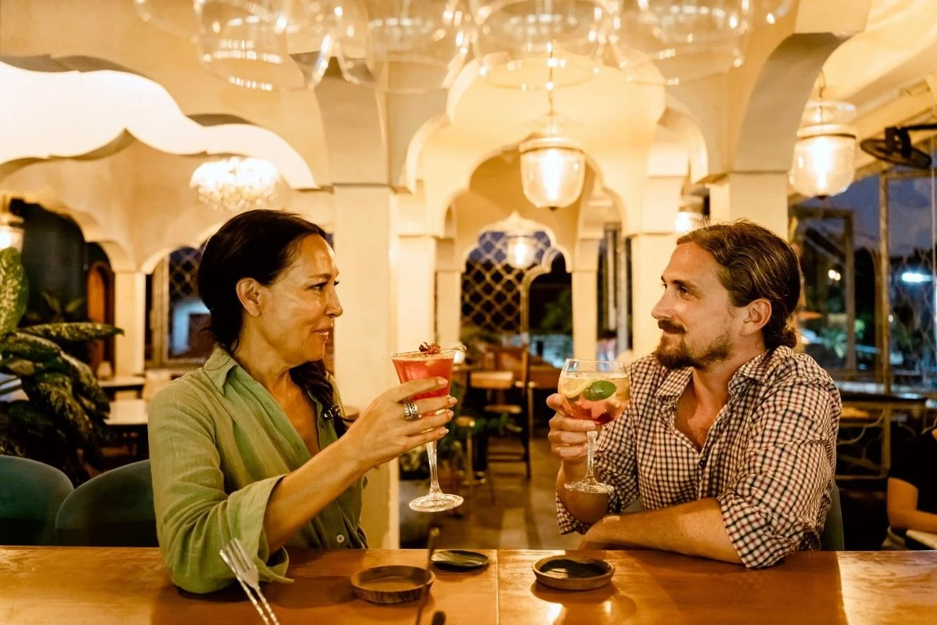 Guests enjoying handcrafted cocktails in a relaxed evening atmosphere at Pesona Lounge, Central Ubud.