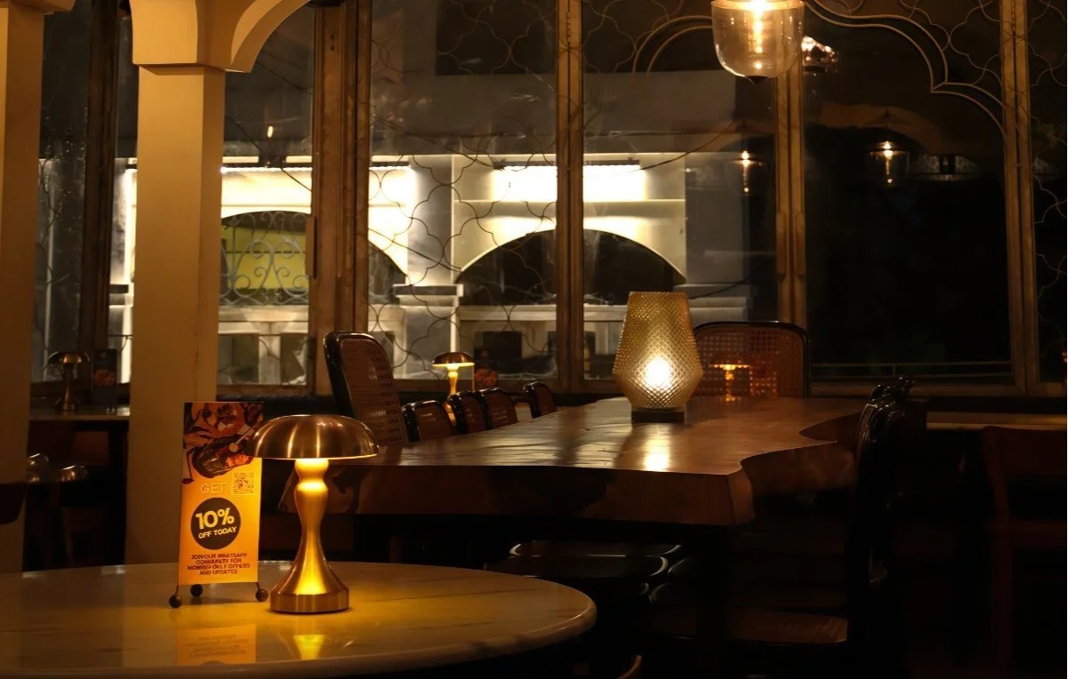 The warmly lit dining area at Pesona Lounge in Ubud during the evening.