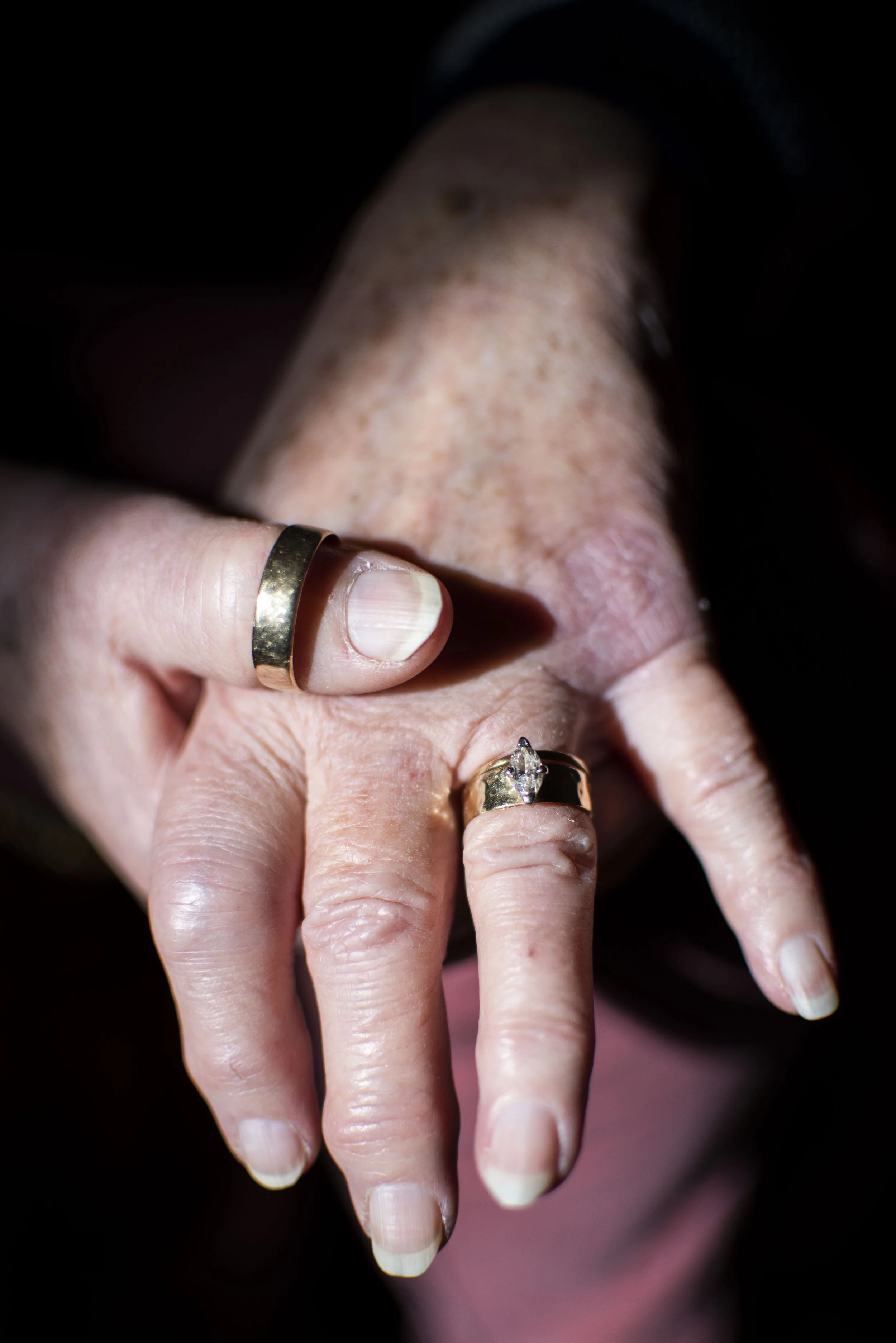  Rozanne Pauze models her’s and Mike Pauze’s, her late husband, wedding rings at her home on Feb. 4, 2022, in Jonesville, MI. Rozanne now wears Mike’s wedding band on a necklace.  