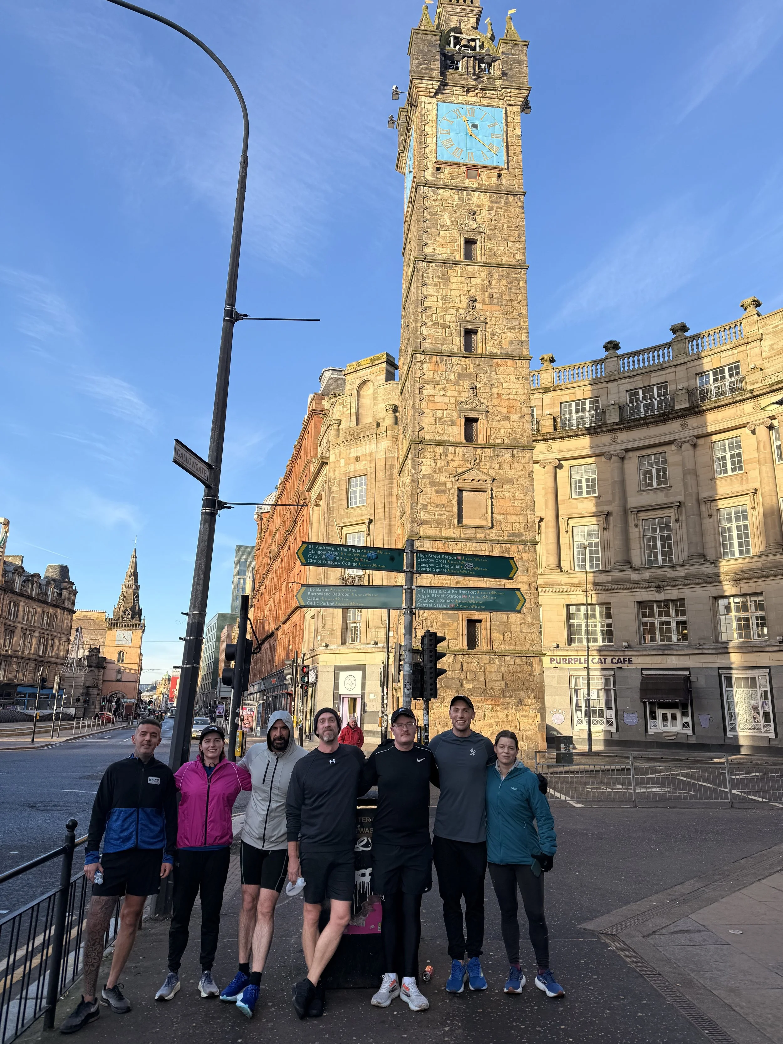A photo of 7 Glasgow FrontRunners in front of the Glasgow Tolbooth on a Sunday morning