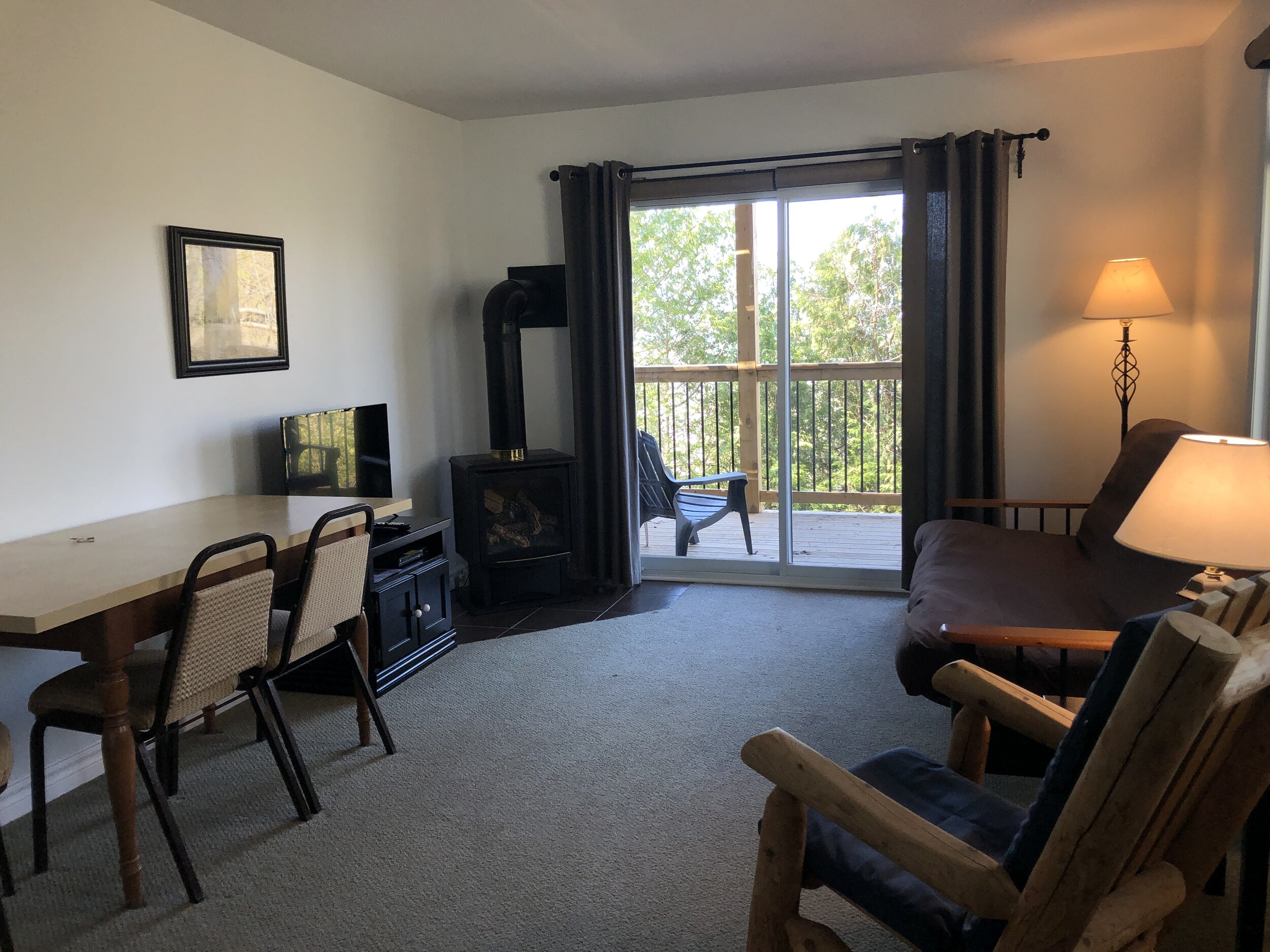 Living room with futon, gas fireplace, tv