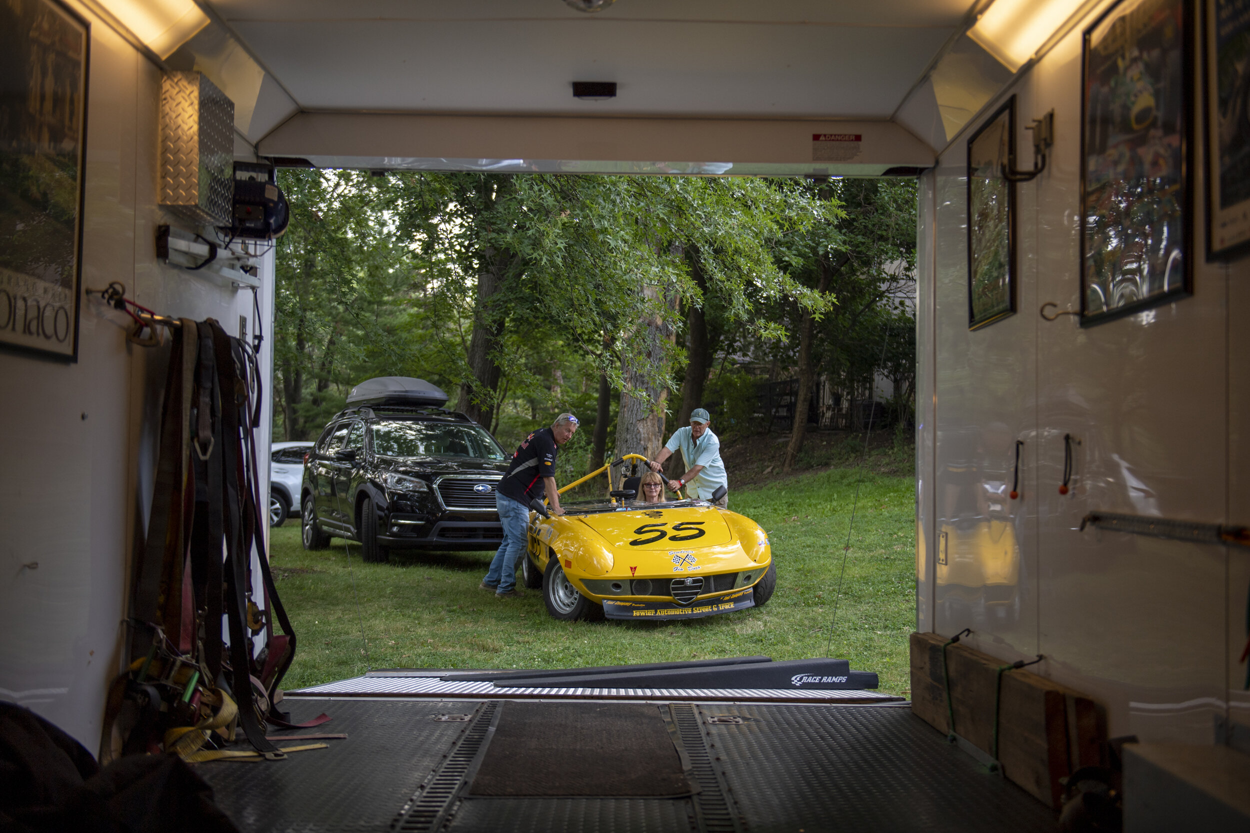  (Left-Right) Joe Mendel and John Bechtol push Dotti Bechtol and her Alfa Romeo 72’ Spider back into their trailer while taking down their Pitt on July 29, 2021, in Pittsburgh, Pa.  