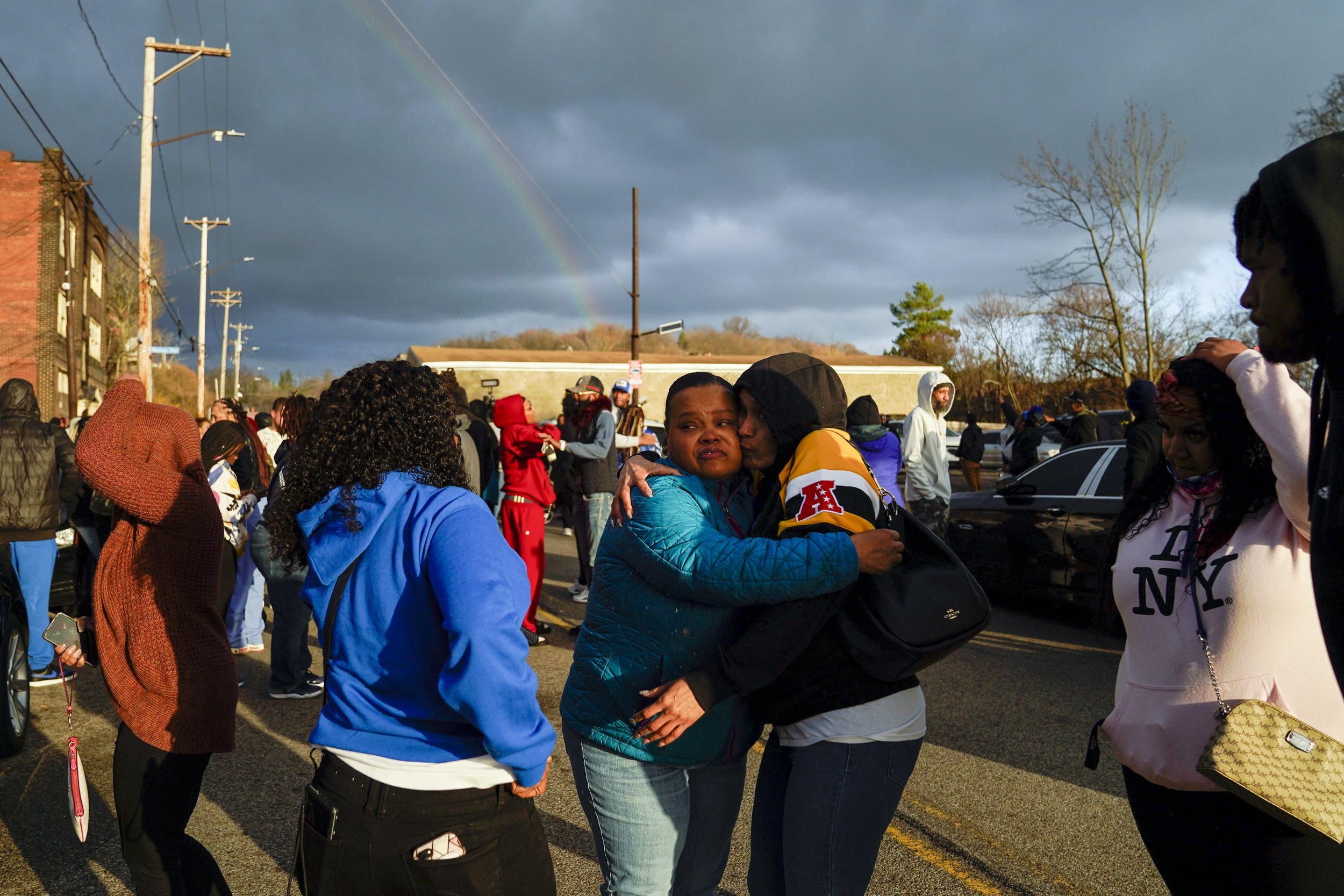  Community members embrace one another after they released balloons in memory of “Day Day” on Monday, March 27, 2023, in Homewood. Day Day was killed Friday with a woman whose identity has yet to be released, after 15 shoots were fired late in the ni
