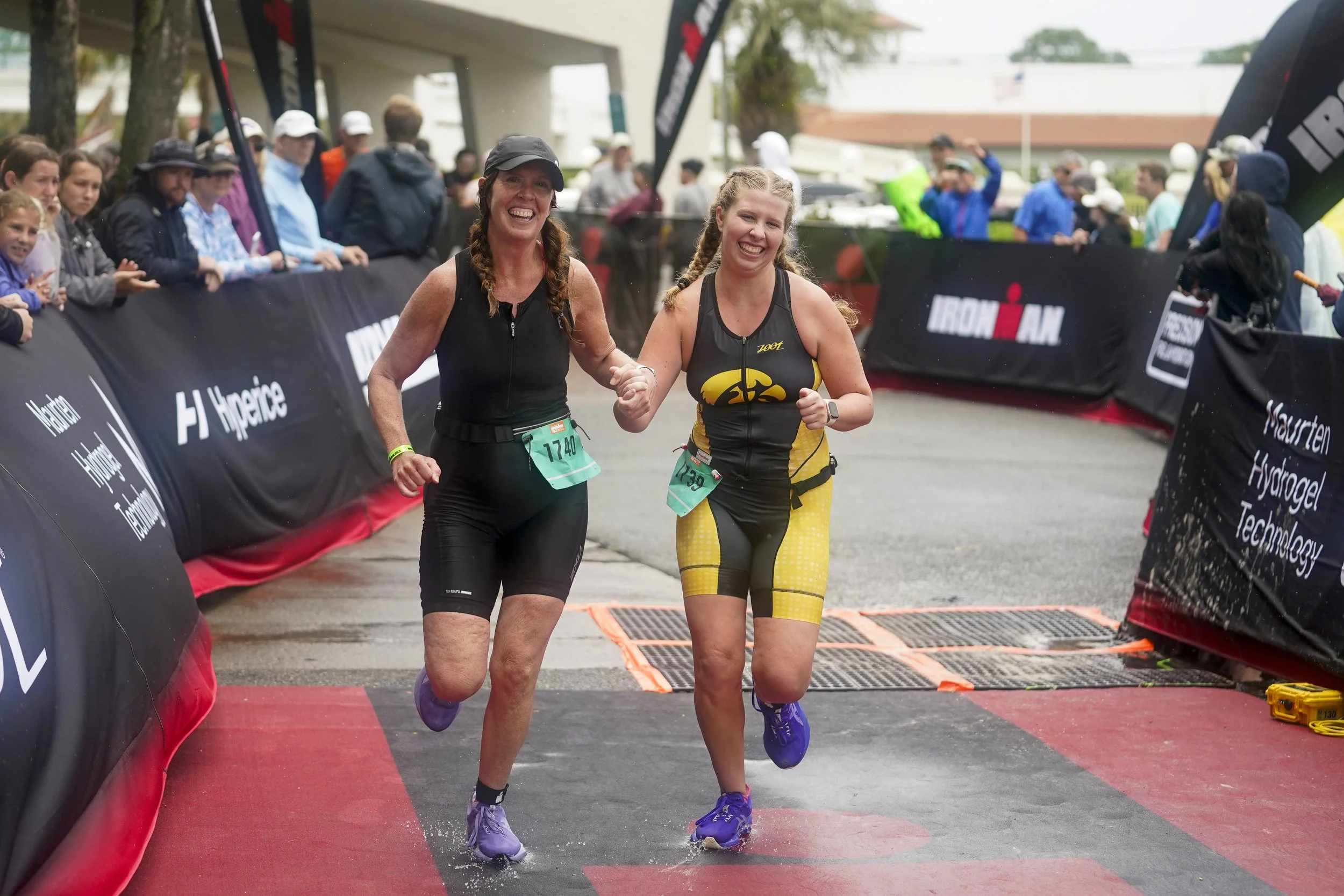  Age-group athletes run towards the finish line of the 2026 IRONMAN 70.3 Gulf Coast on May 9, 2026, in Panama City Beach, Florida. (Photo by Benjamin B. Braun/Getty Images for IRONMAN) 
