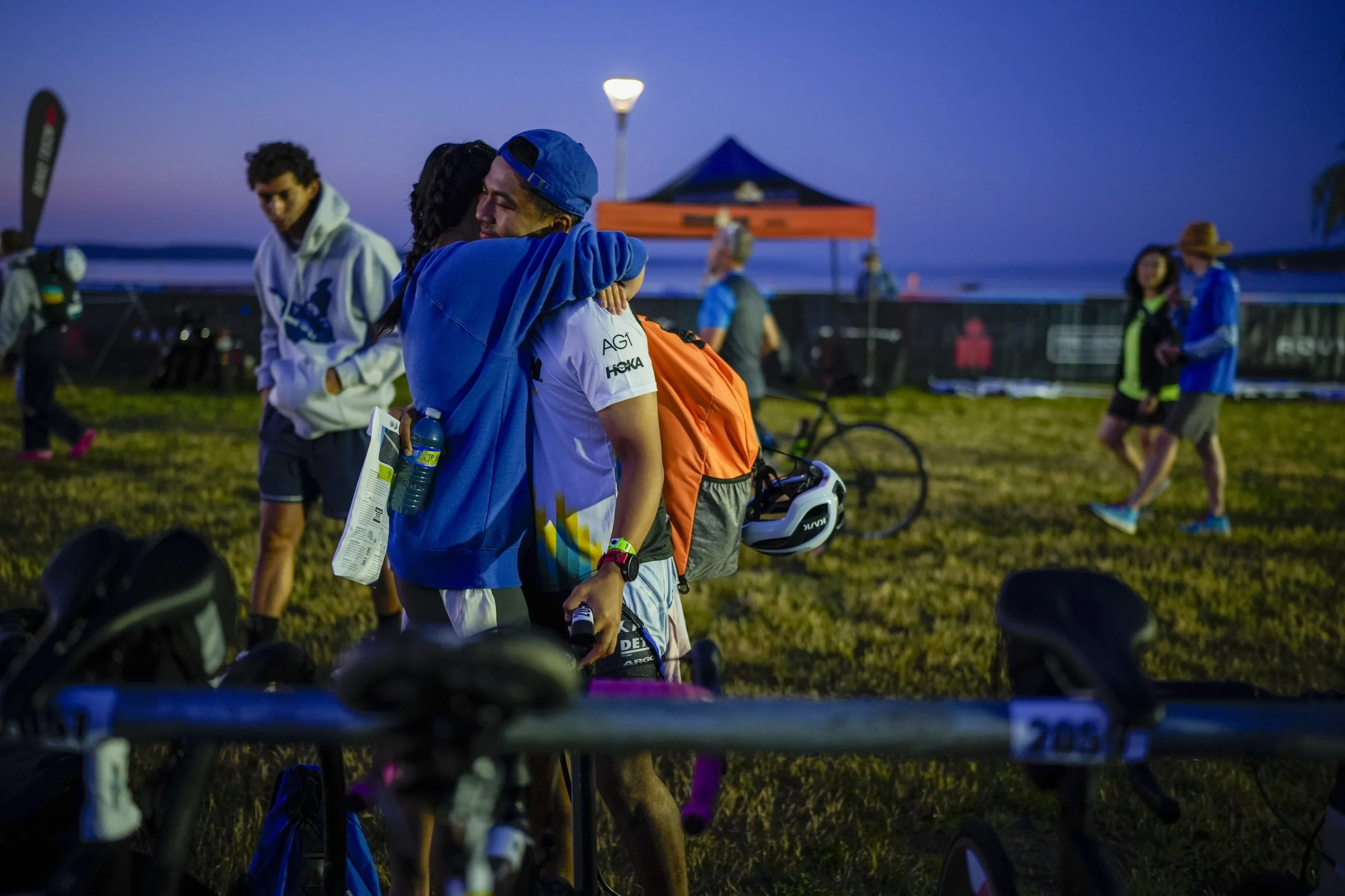  Age group athletes hug in the transition area before competing in IRONMAN 70.3 Musselman on July 12, 2026 in Geneva, New York. (Photo by Benjamin B. Braun/Getty Images for IRONMAN) 