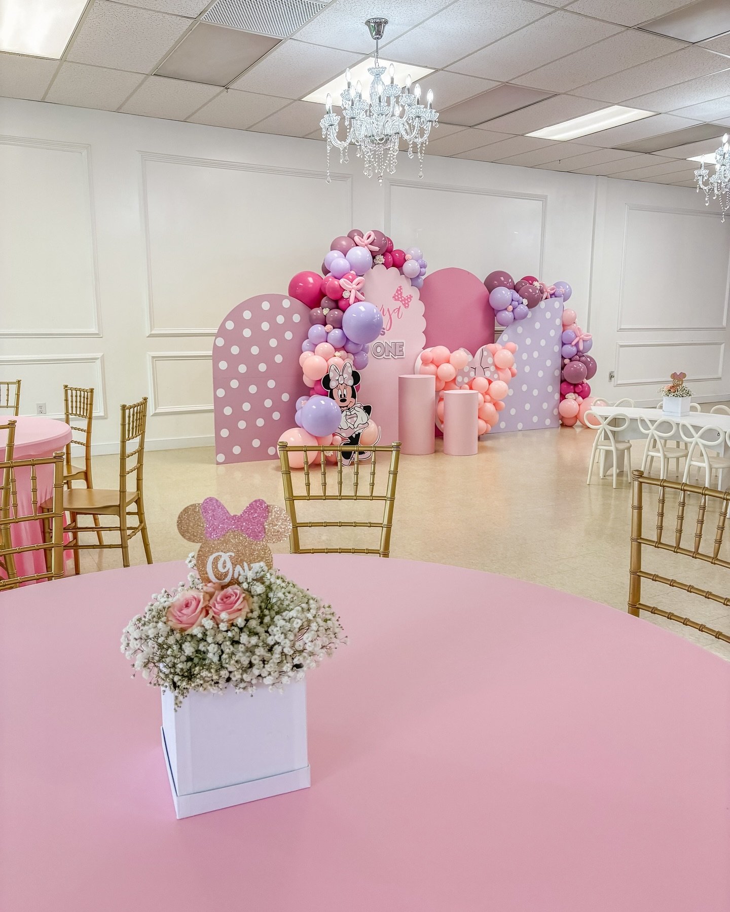 We adore creating floral arrangements that perfectly complement the theme! For this Minnie Mouse 1st birthday celebration, we selected delicate baby&rsquo;s breath &amp; soft pink roses, &amp; crafted custom Minnie head toppers. It&rsquo;s all in the