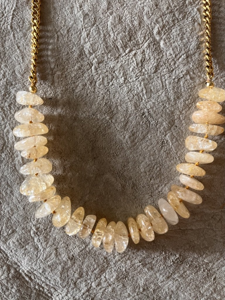 Gorgeous sunny citrine uplifts the spirit and centers your being, Hand knotted citrine stones paired with a classic gold chain elevates your spirit and look. Hangs mid chest.