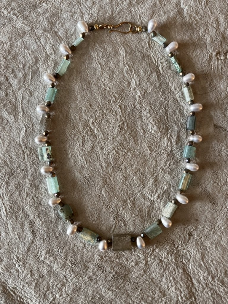 roman era glass beads that have stood the test of time are paired with fresh water pearls to create a modern classic.