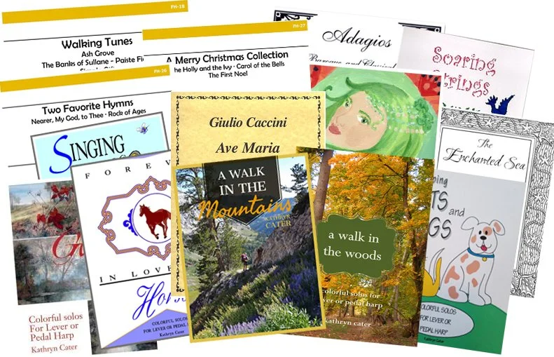 Pile of sheet music by Kathryn Cater for harp solo, harp duet, harp and flute.