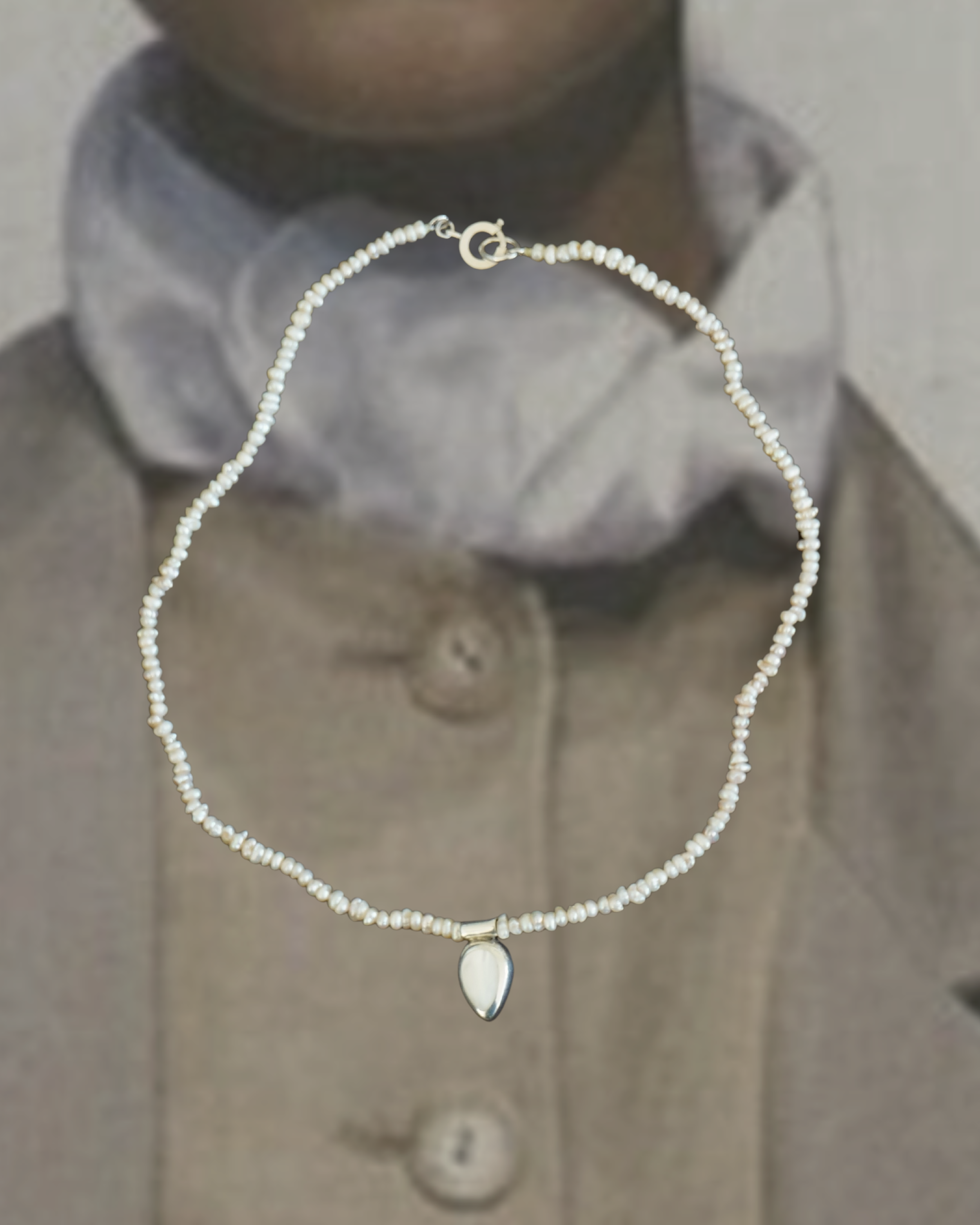 Reclaimed rice pearl necklace with vintage silver & mother of pearl pendant