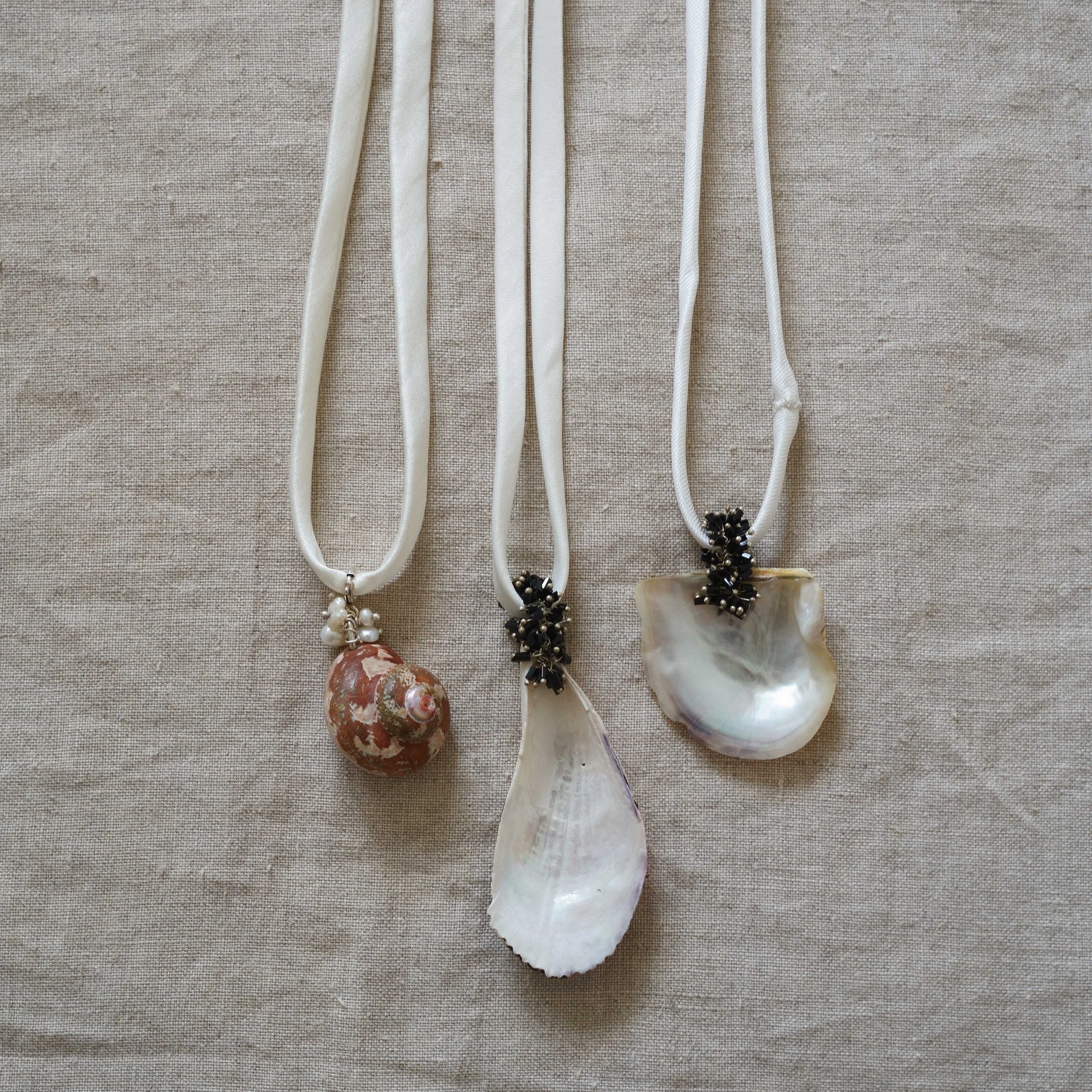 Shell pendants on white satin