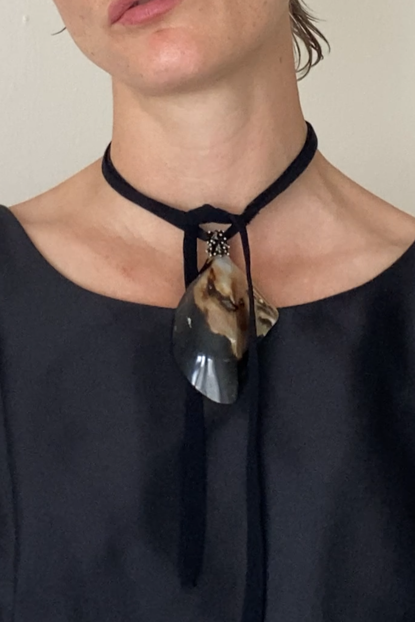 Mussel shell pendants on black fabric