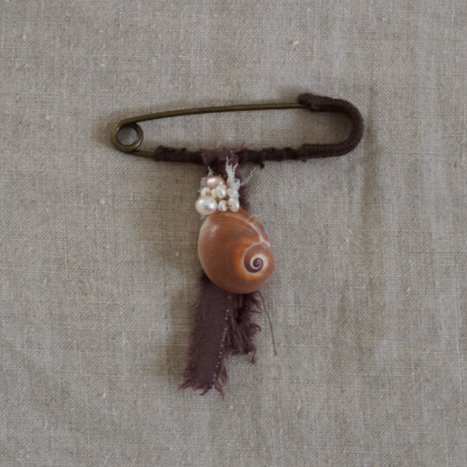 Brass kilt pin with pearl & shell adornment