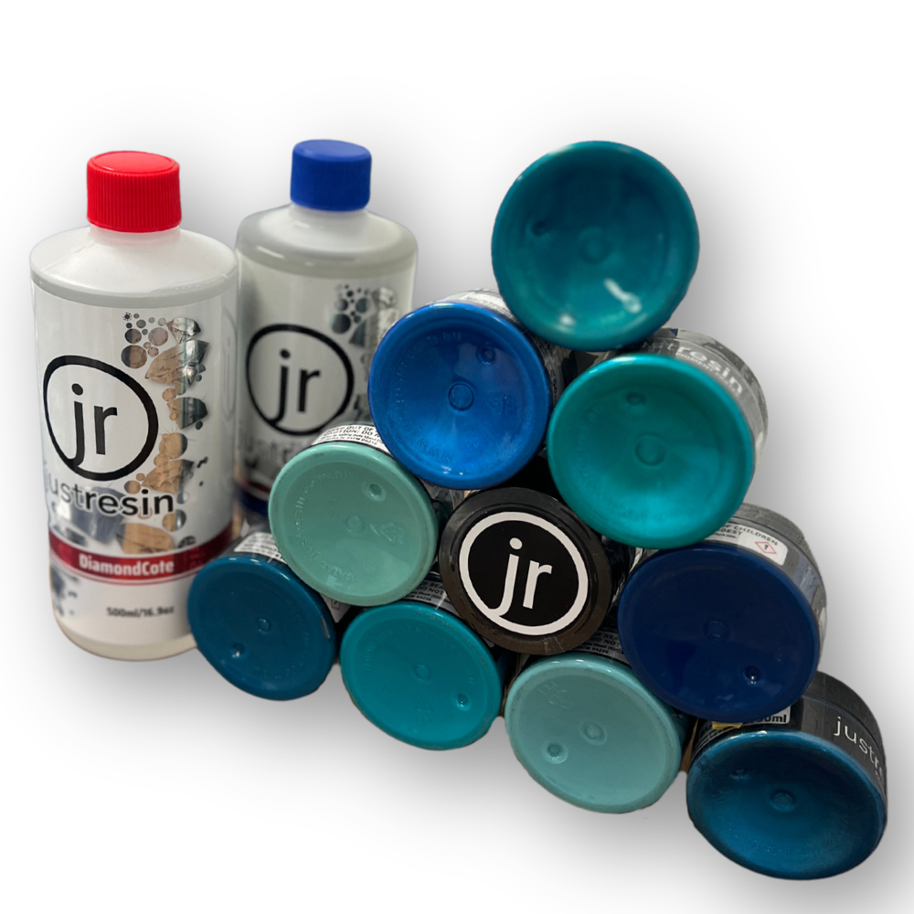 A collection of glue sticks with blue, turquoise, and black caps, some with the brand 'jr' visible, arranged on a white background.