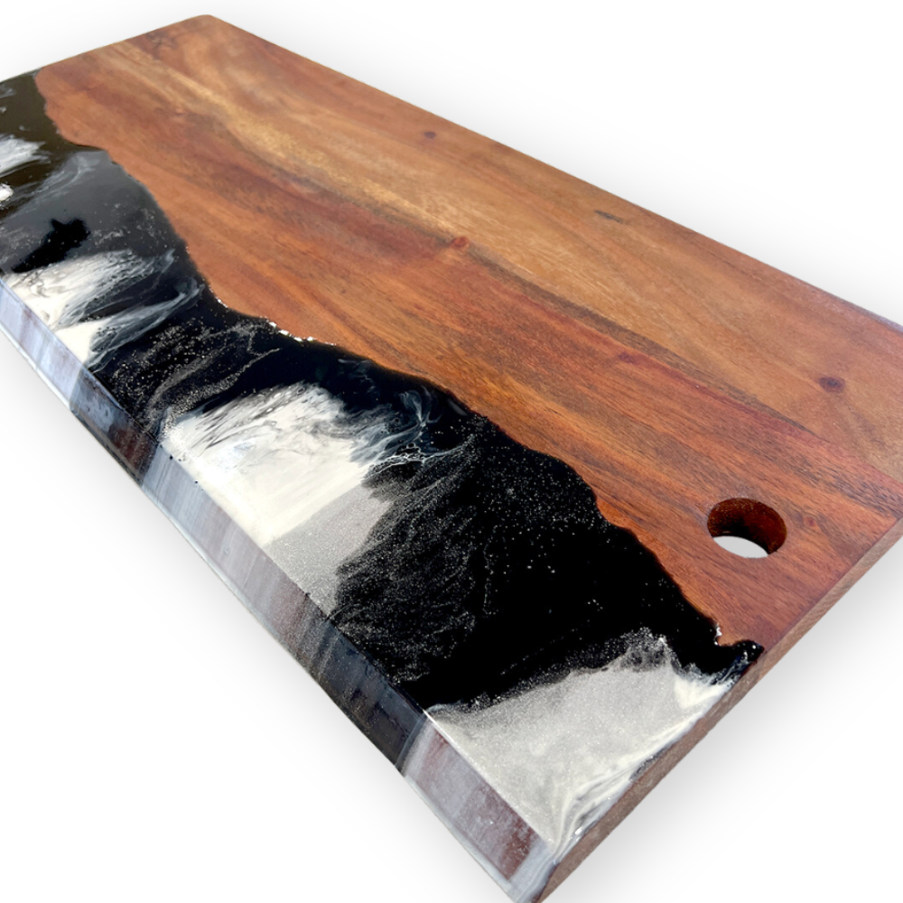 A wooden table with a black and white resin river design.