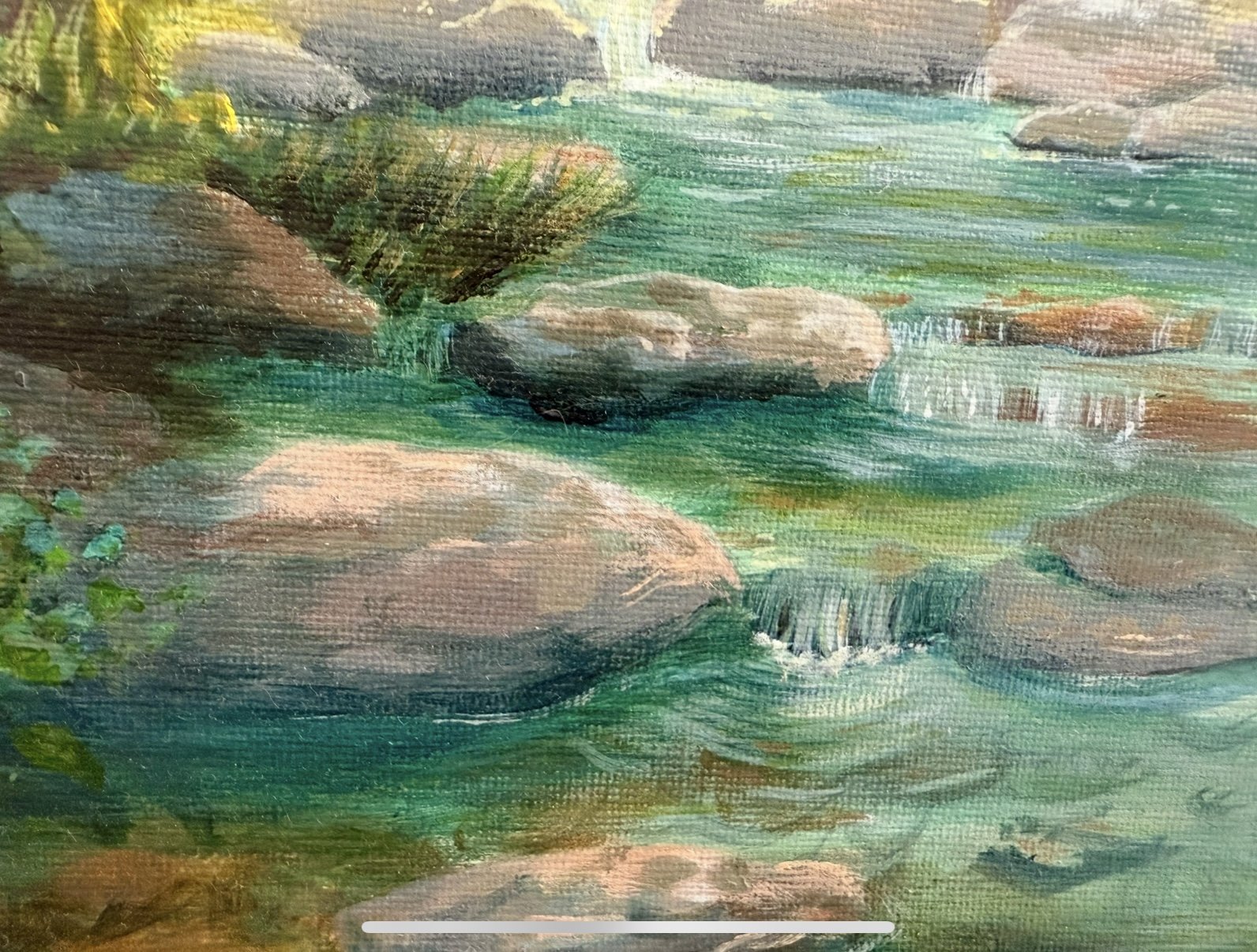 close-up of acrylic stream with water running over boulders