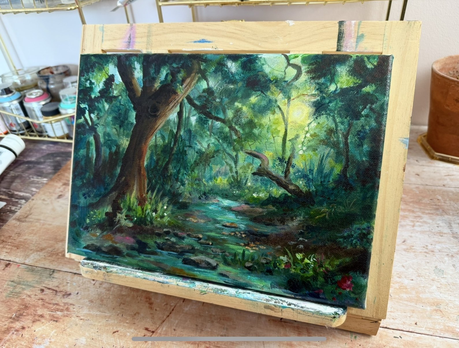 small acrylic woodland painting on an easel