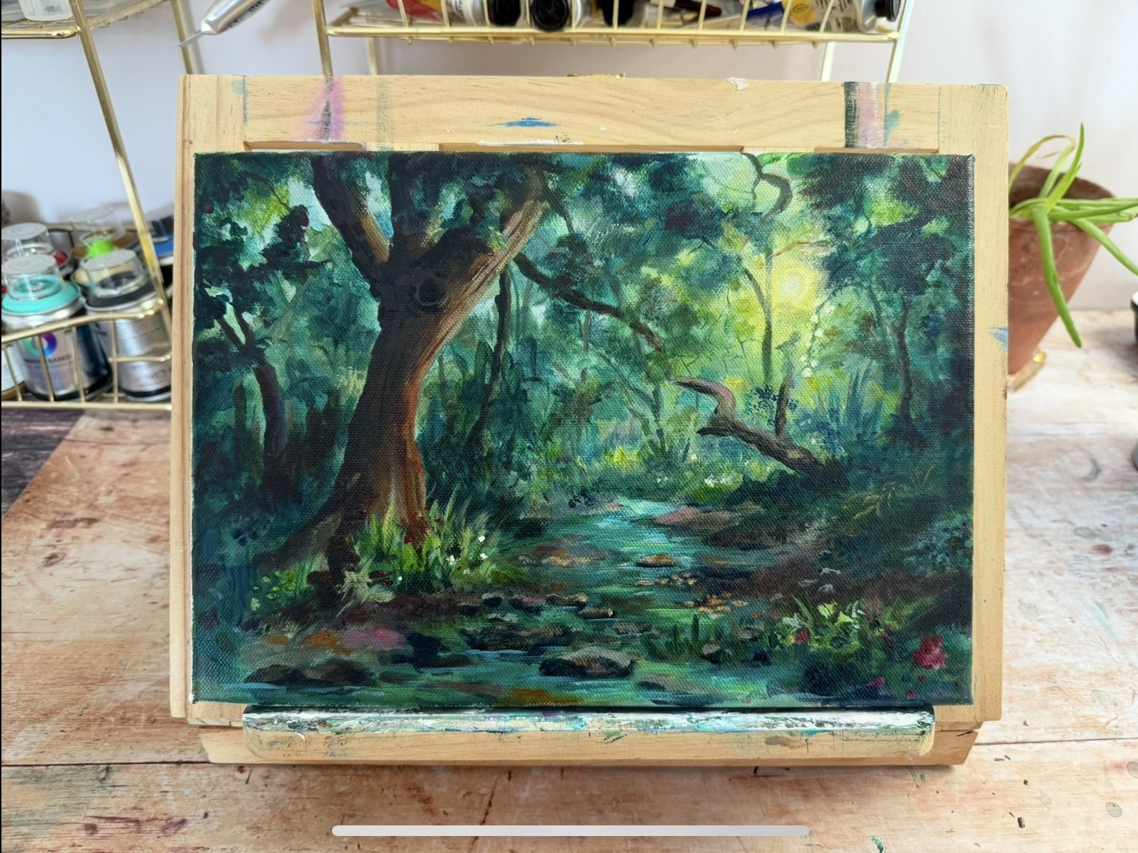 fantasy forest landscape painting on an easel