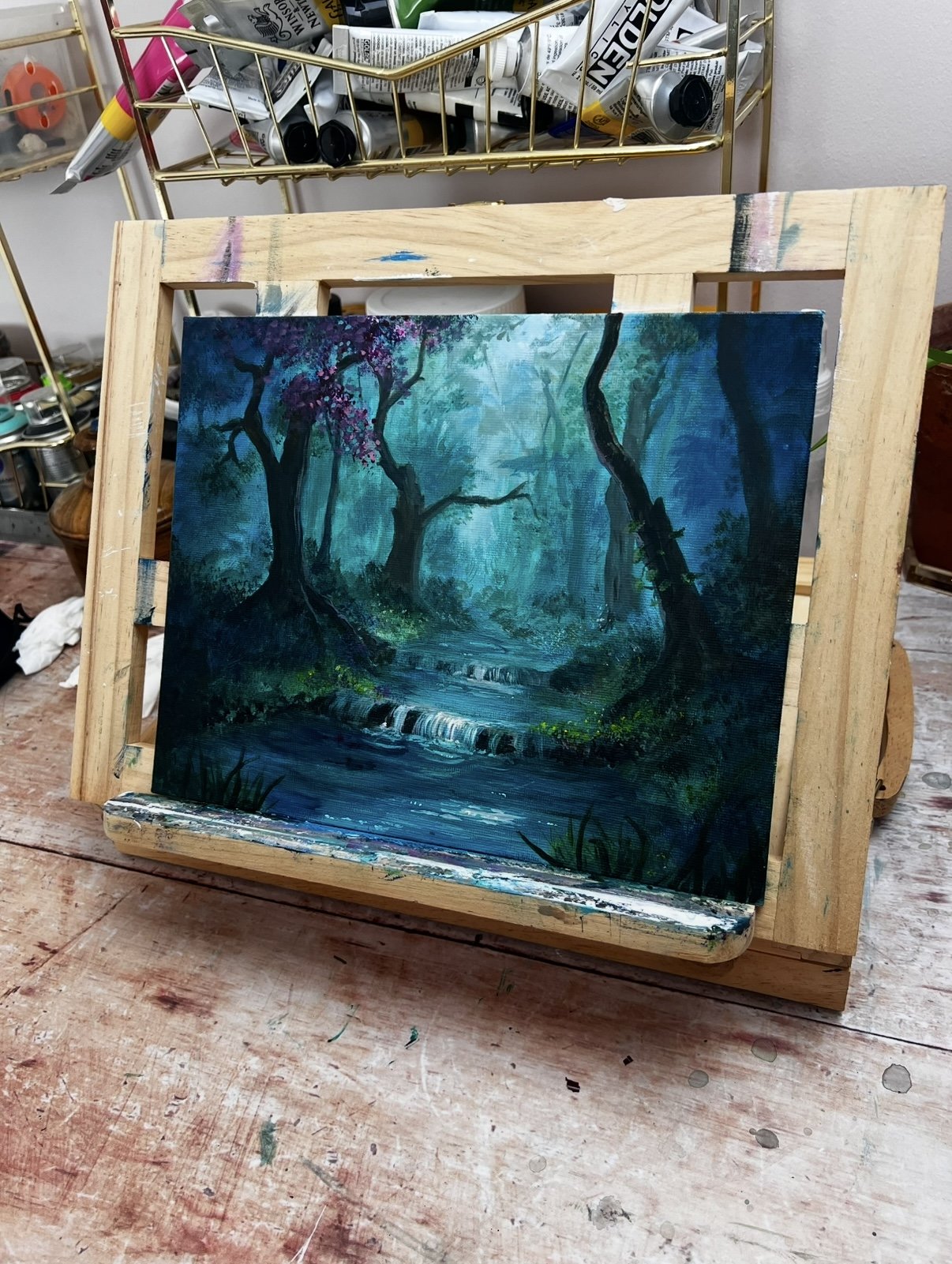 vibrant forest painting on easel