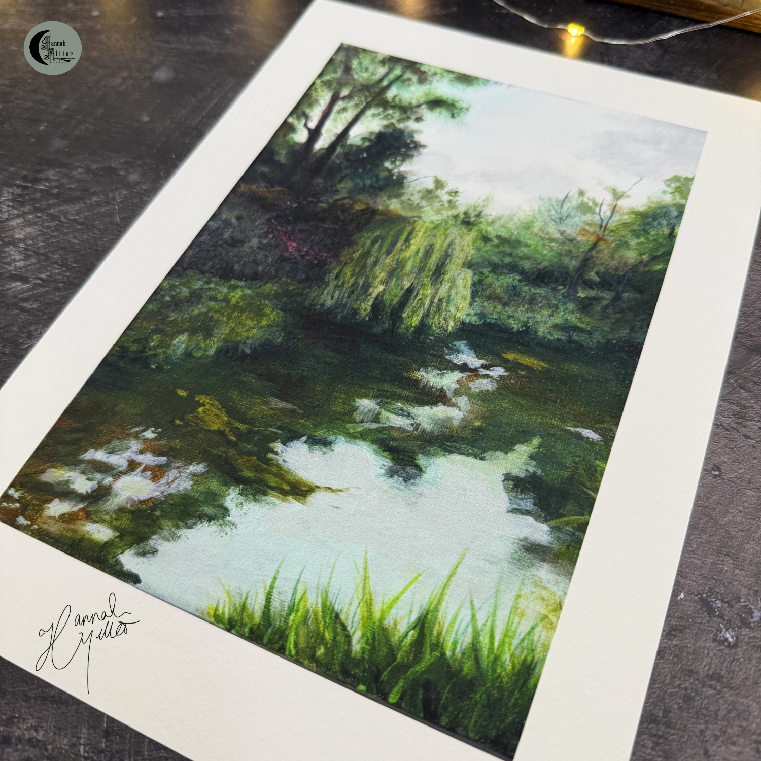 a fine art print of trees by a river with reflections